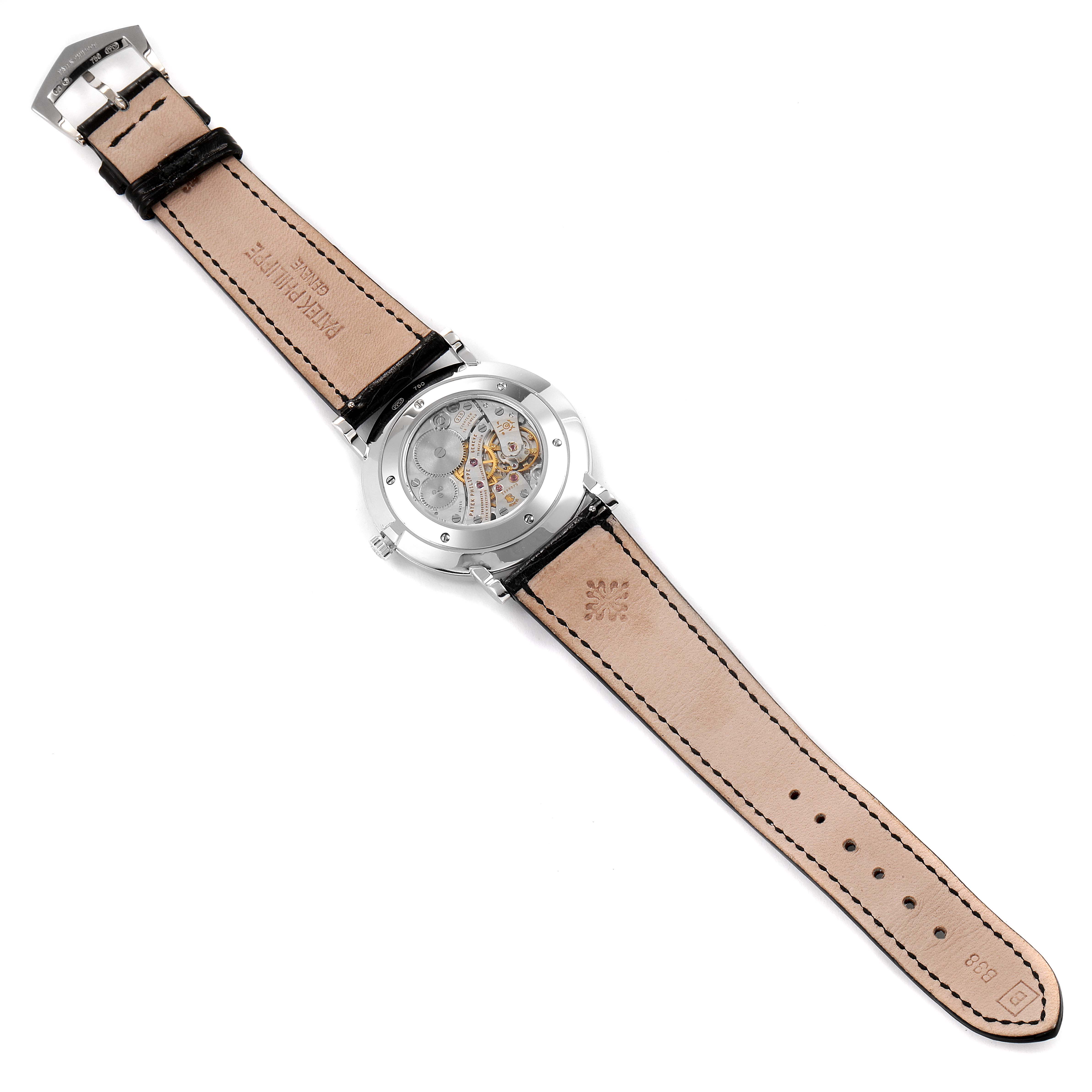 The image shows the back view of a Patek Philippe Calatrava 5119G Men's White Gold White Dial 5119G Men's White Gold White Dial watch, highlighting its transparent case back and leather strap.