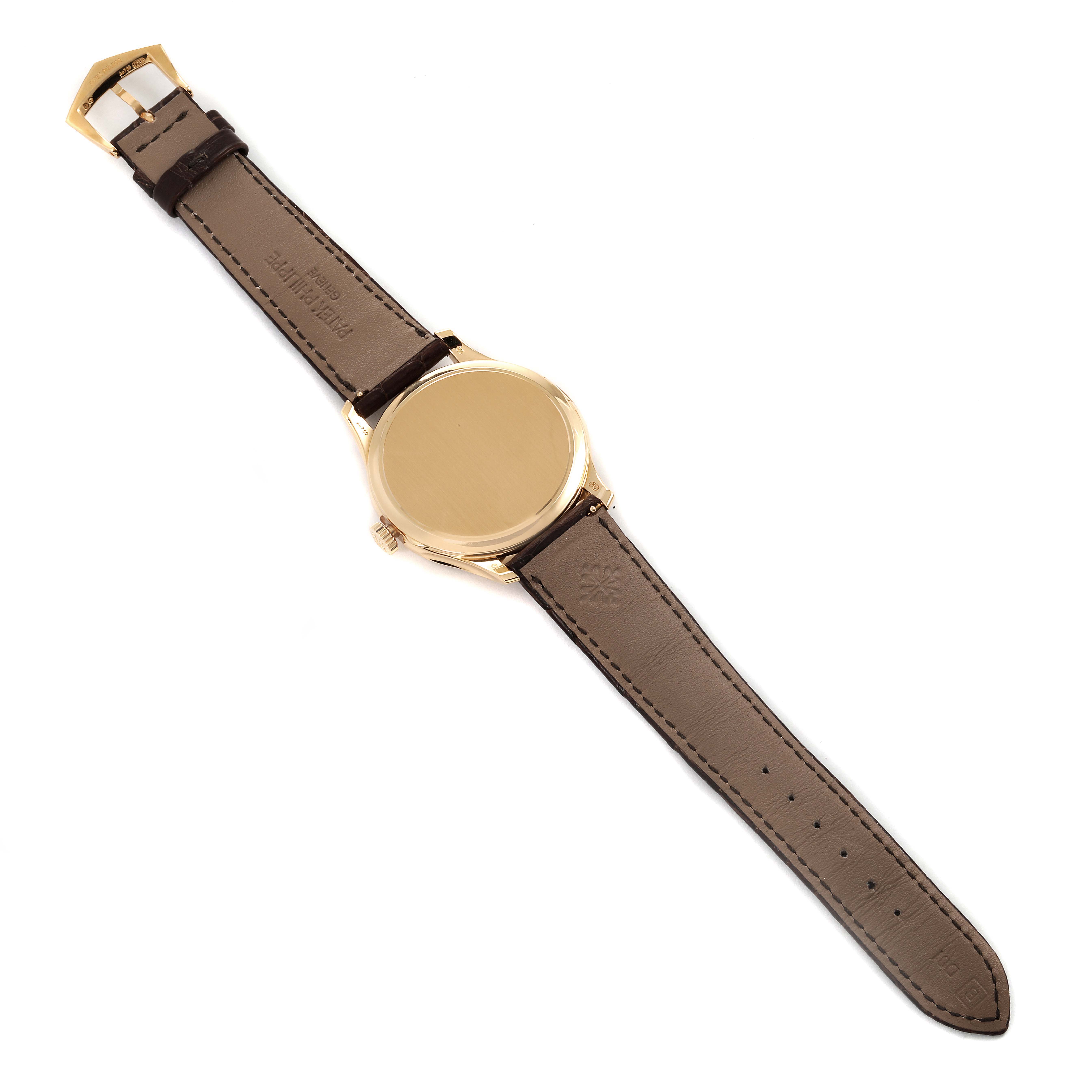 The image shows the back view of a Patek Philippe Calatrava 5227J-001 Men's Yellow Gold Beige Dial 5227J-001 Men's Yellow Gold Beige Dial watch, highlighting its leather strap and buckle.