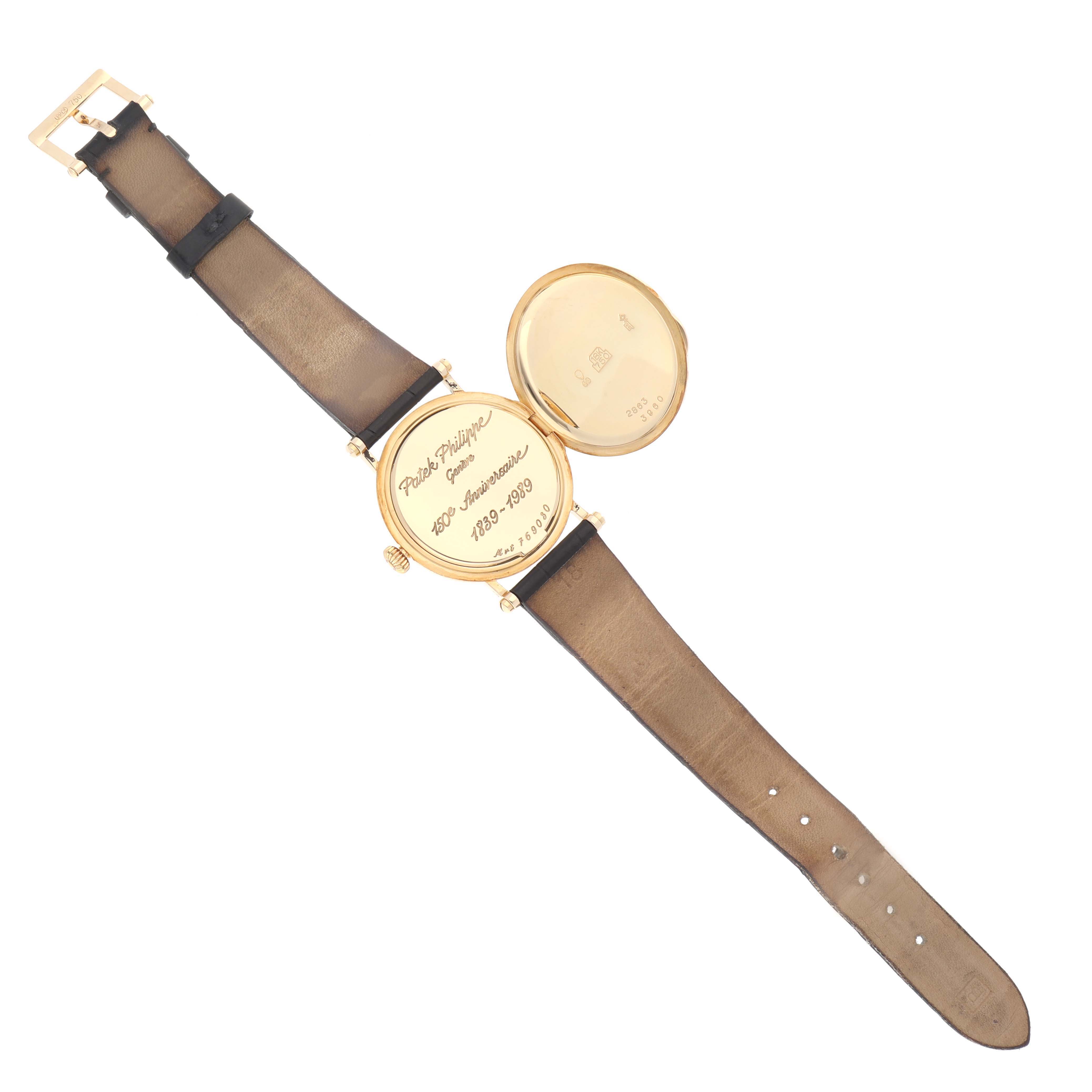 The image shows the back and strap of a Patek Philippe Calatrava 3960J Men's Yellow Gold White Dial 3960J Men's Yellow Gold White Dial watch with an open case back, revealing an inscribed cover.