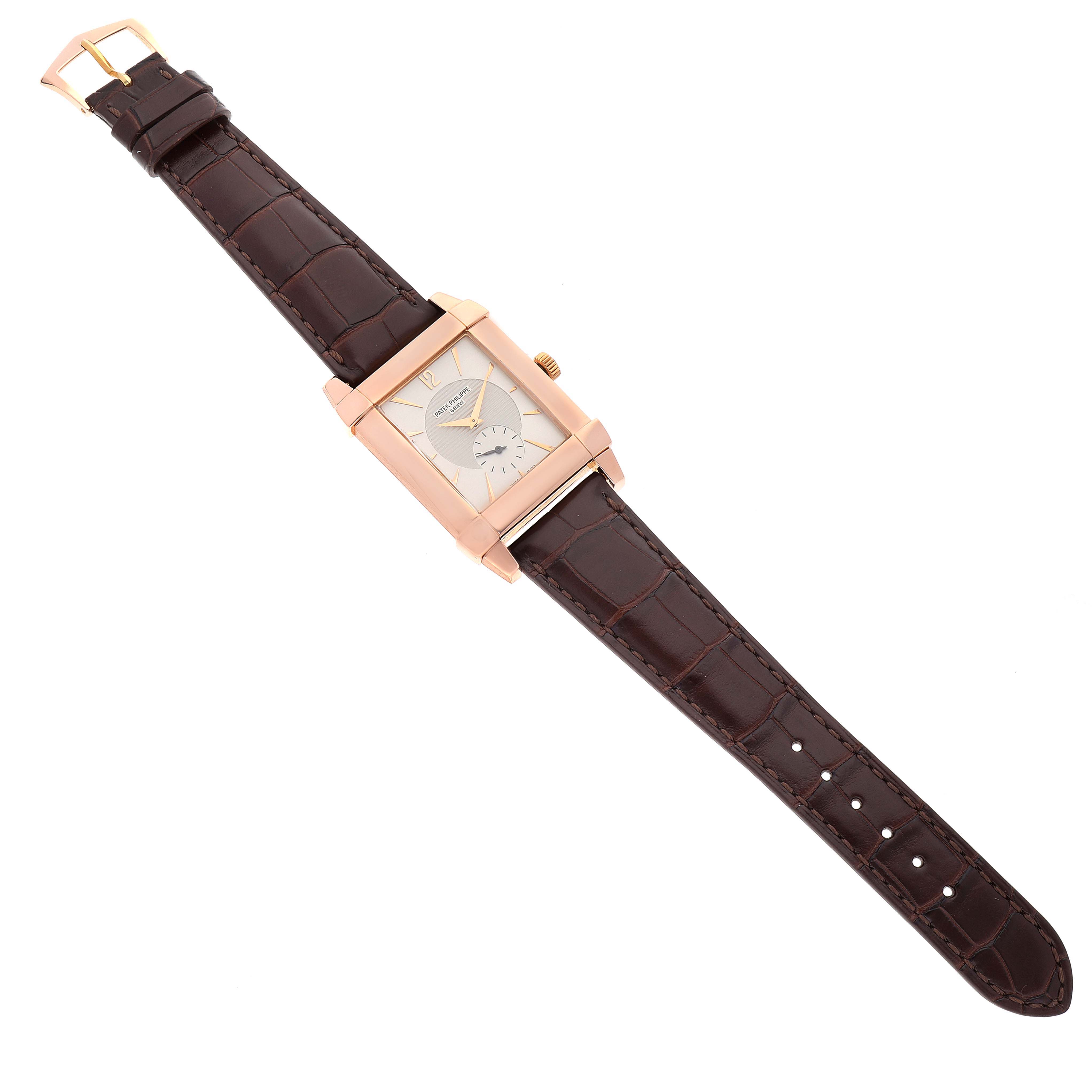 The image shows a top-down view of a Patek Philippe Gondolo 5111R Men's Rose Gold Silver Dial 5111R Men's Rose Gold Silver Dial watch with a rectangular face and a brown leather strap.