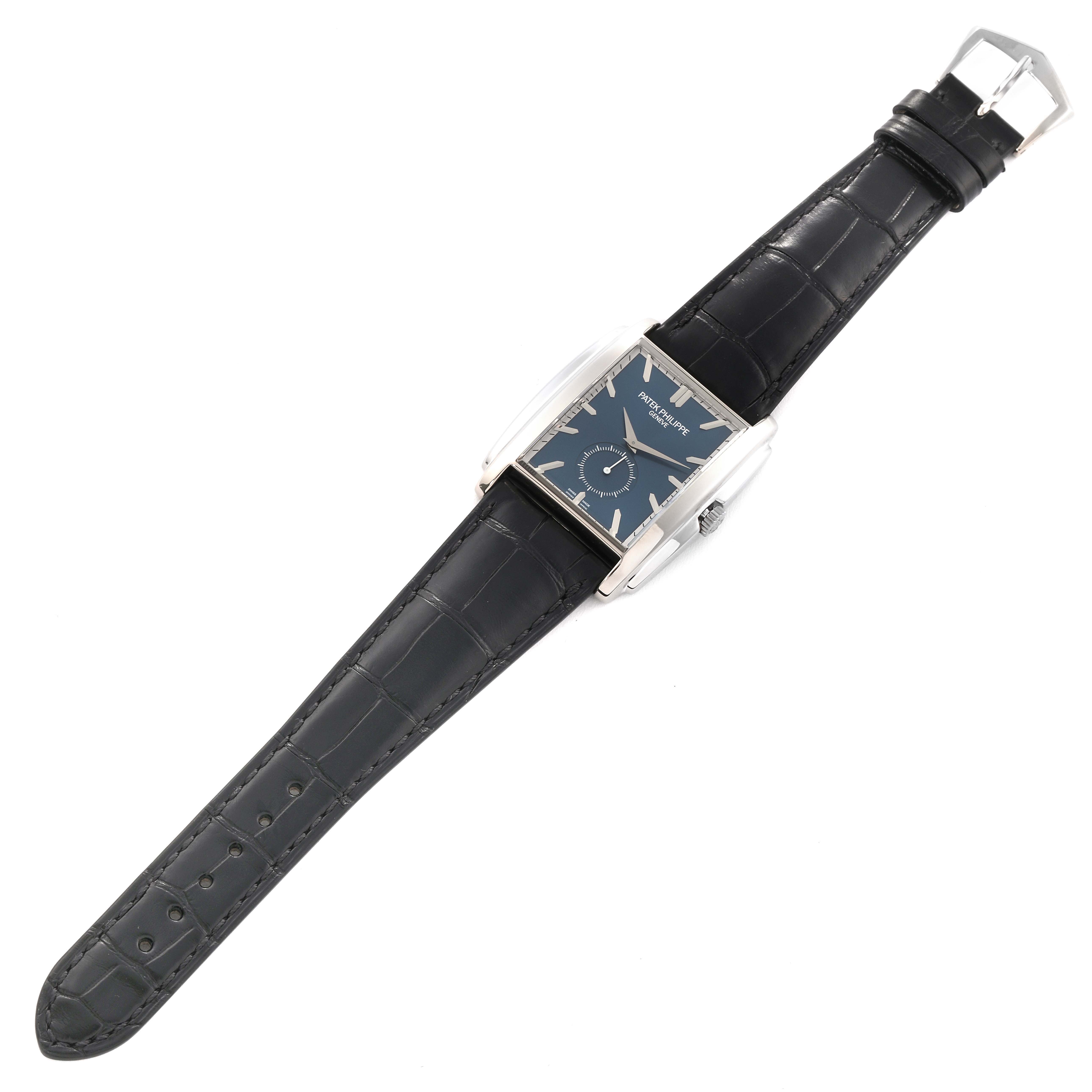 The image shows a top-down view of a Patek Philippe Gondolo 5124G-011 Men's White Gold Blue Dial 5124G-011 Men's White Gold Blue Dial watch with a black leather strap and a rectangular dial.