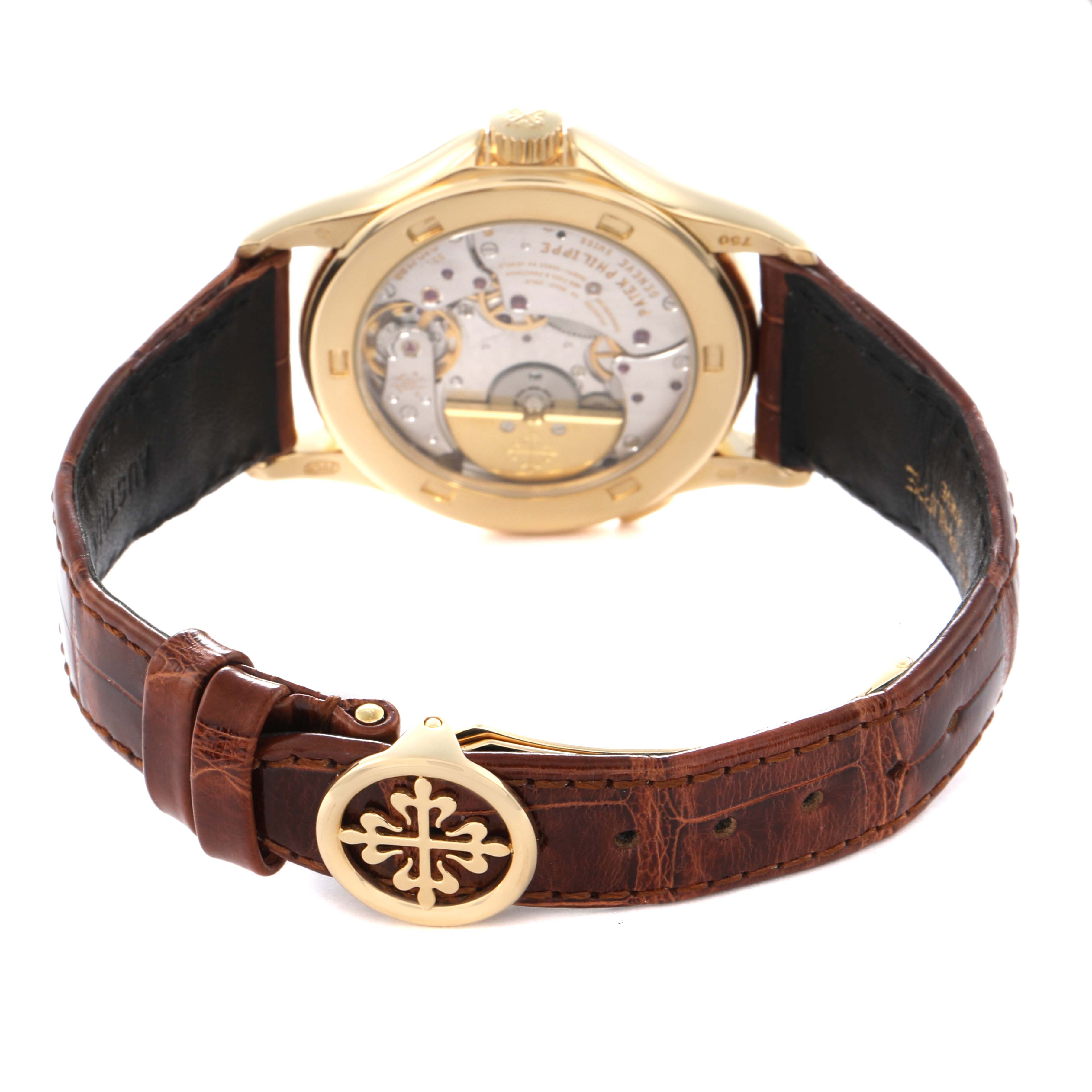 The image shows the back of the Patek Philippe Complications model 5110J-001 watch, featuring its movement and brown leather strap with an ornate clasp.