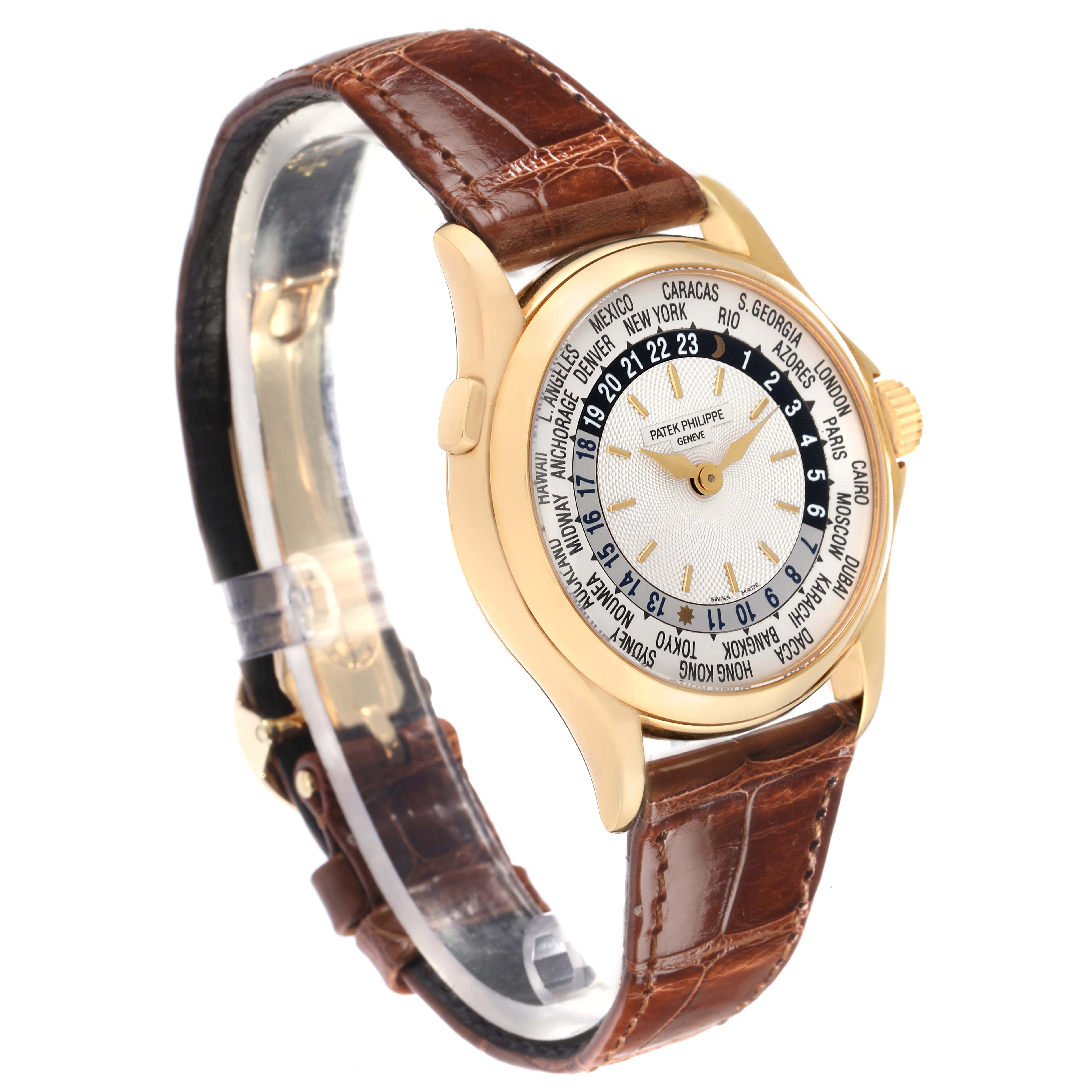 The Patek Philippe Complications 5110J-001 is shown at an angled side view, displaying the watch face, gold casing, world time features, and brown leather strap.