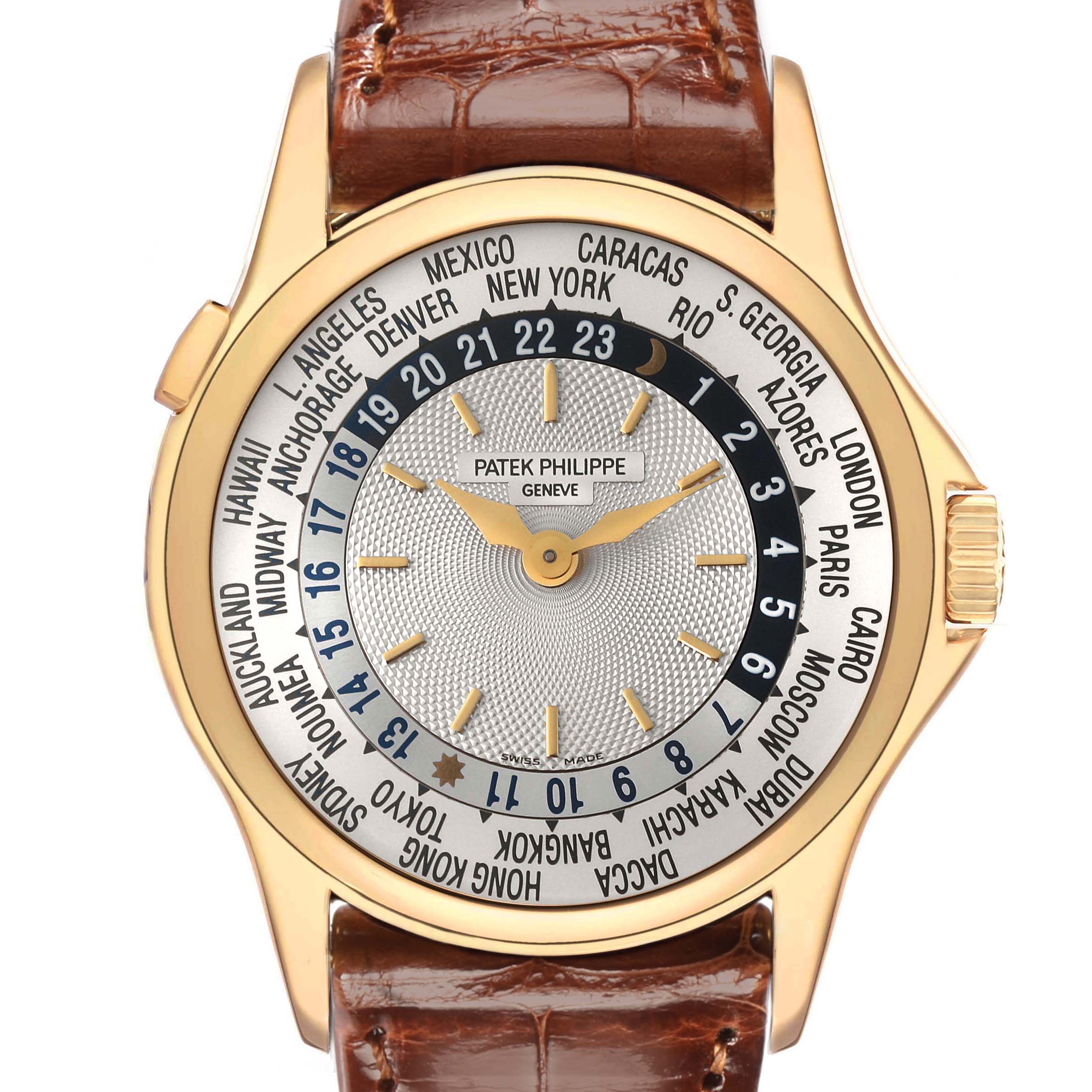 The Patek Philippe Complications model 5110J-001 is shown from a top-down angle, highlighting its world time dial, gold case, and brown leather strap.