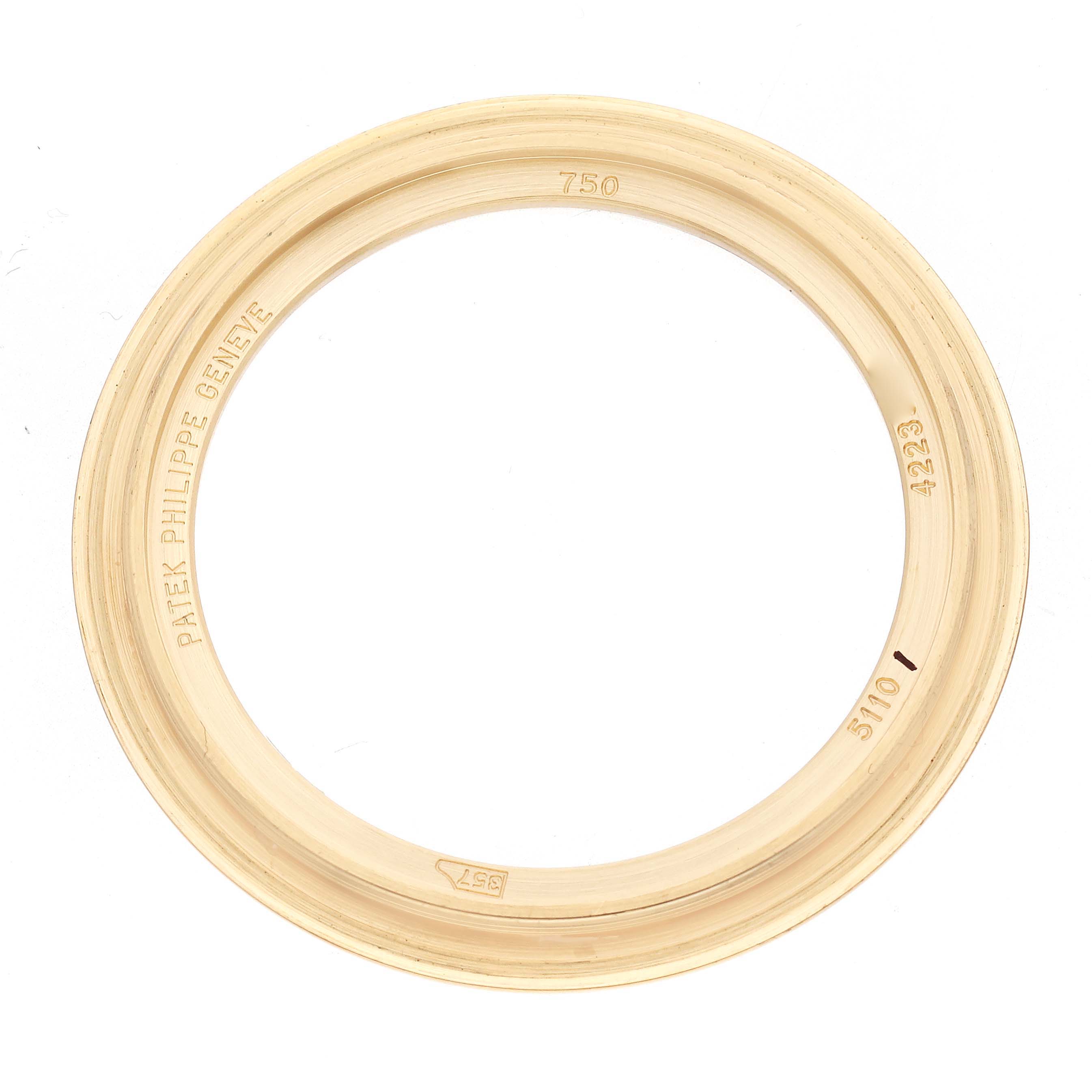 The image shows a gold bezel from a Patek Philippe Complications model 5110J-001, viewed from above.