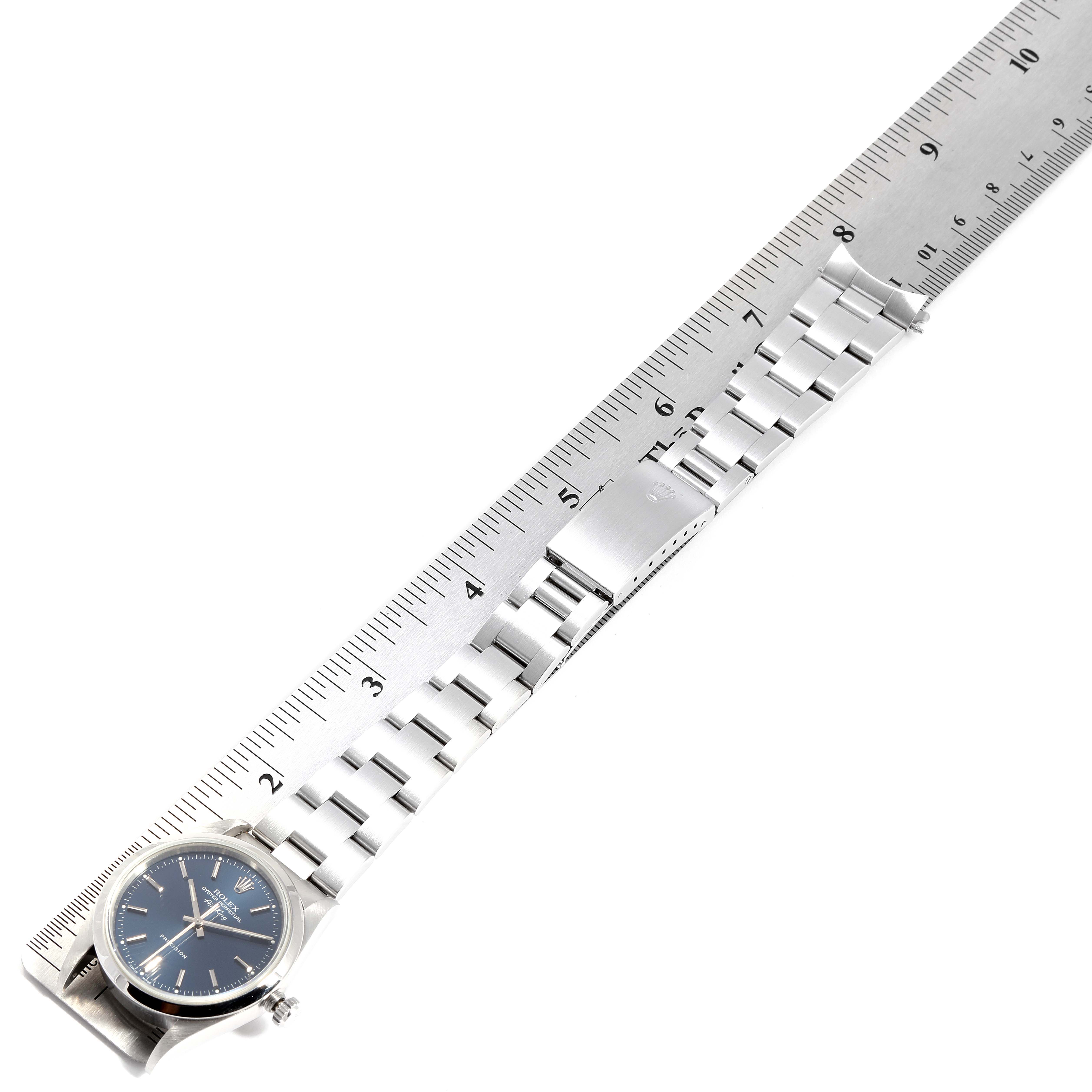 The image shows a Rolex Air-King 14000M Men's Stainless Steel Blue Dial 14000M Men's Stainless Steel Blue Dial watch laid flat next to a ruler, displaying the face and full metal bracelet at an angle.
