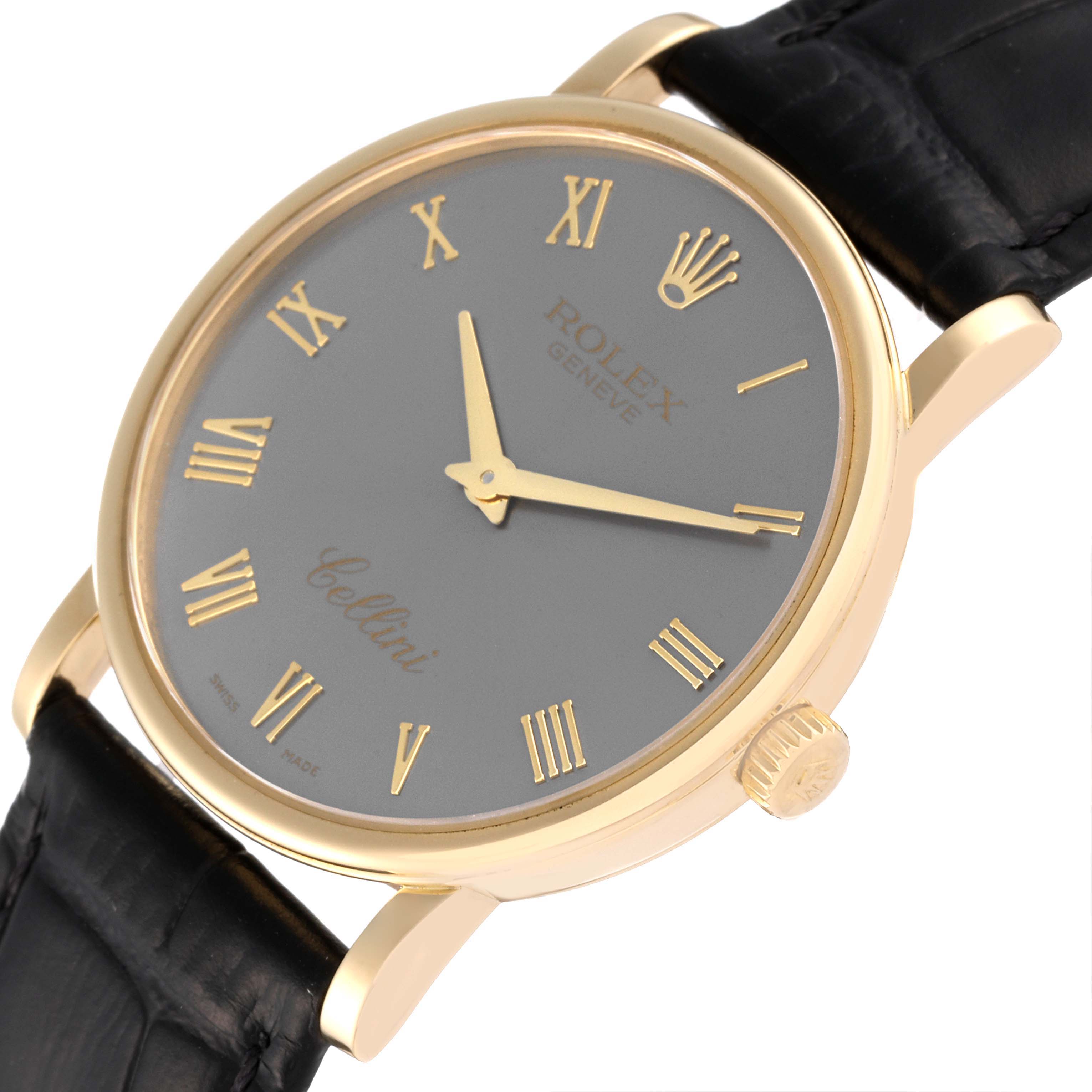 The Rolex Cellini 5115 Men's Yellow Gold Grey Dial 5115 Men's Yellow Gold Grey Dial watch is shown from a slightly angled top-down view, displaying the face, case, crown, and part of the leather strap.