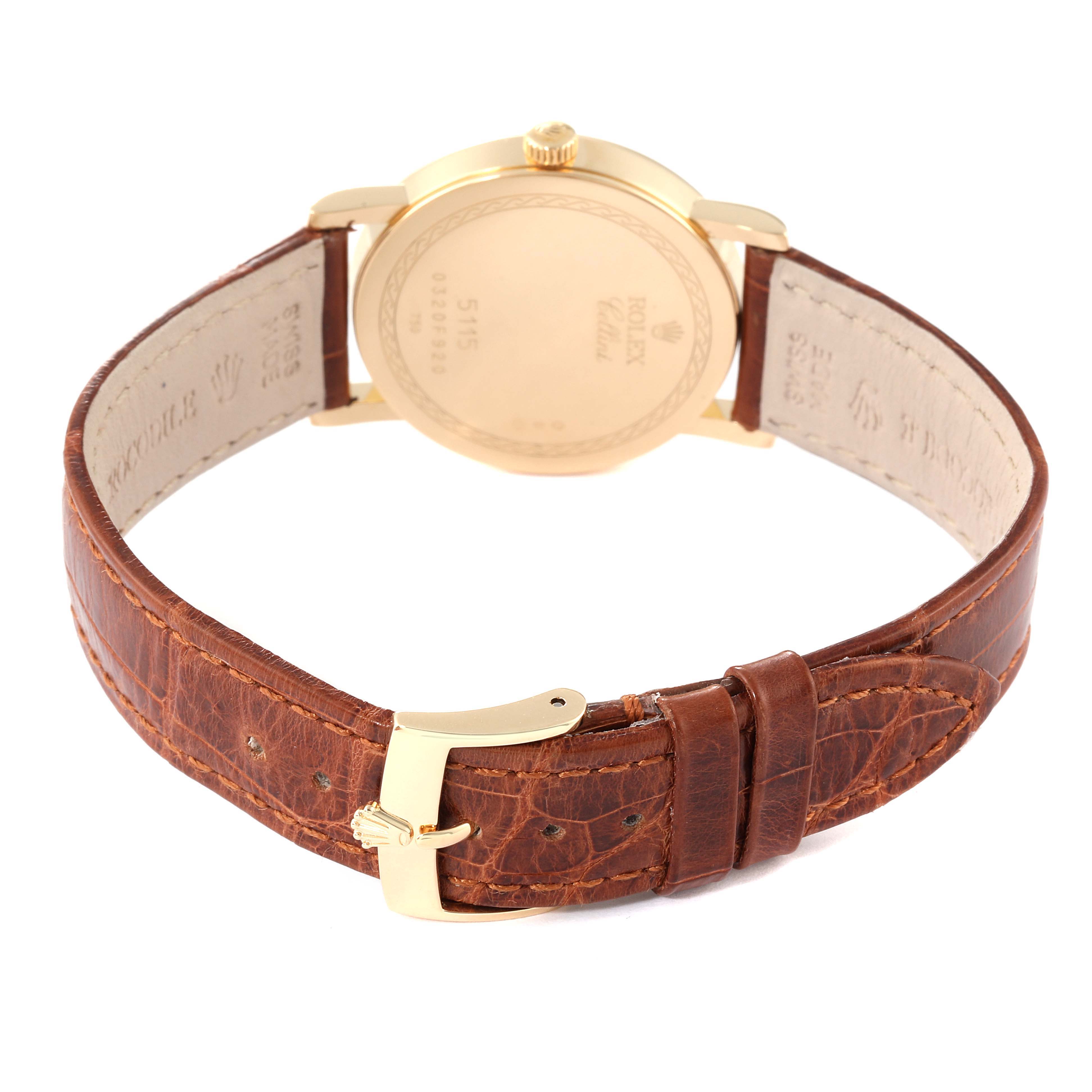This image shows the back case and brown leather strap of a Rolex Cellini 5115 Men's Yellow Gold Silver Dial 5115 Men's Yellow Gold Silver Dial watch.