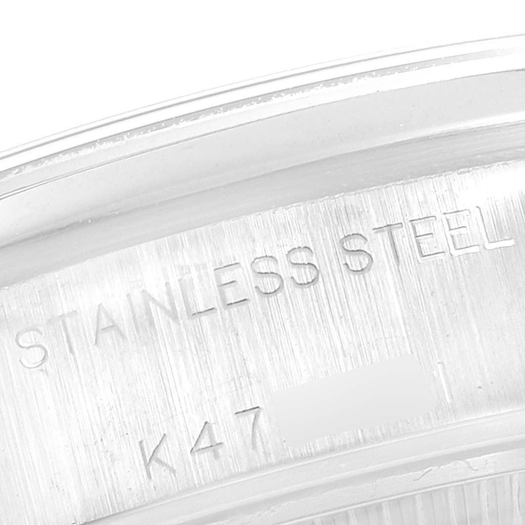 This image shows a close-up of the case back edge of a Rolex Date 79160 Women
s Stainless Steel Blue Dial 79160 Women
s Stainless Steel Blue Dial model, revealing the "STAINLESS STEEL" engraving.