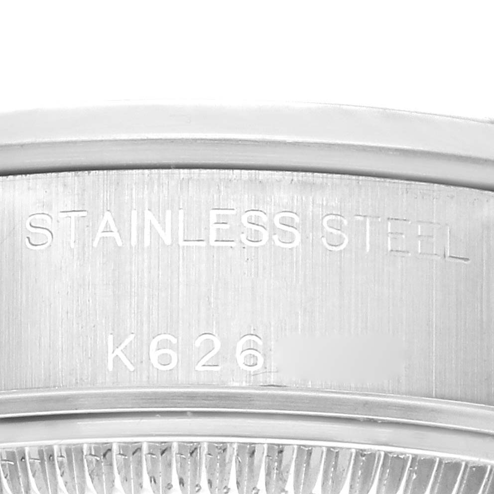 This close-up angle shows the inner caseback of a Rolex Date 79160 Women's Stainless Steel Pink Dial 79160 Women's Stainless Steel Pink Dial model watch, displaying "STAINLESS STEEL" and part of a reference or serial number.