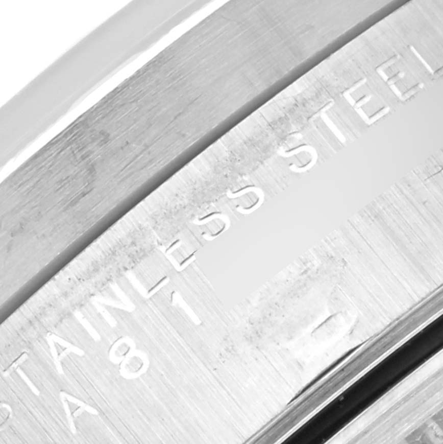 The image shows a close-up of the engraved stainless steel component of a Rolex Date 15210 Men
s Stainless Steel Black Dial 15210 Men
s Stainless Steel Black Dial watch.