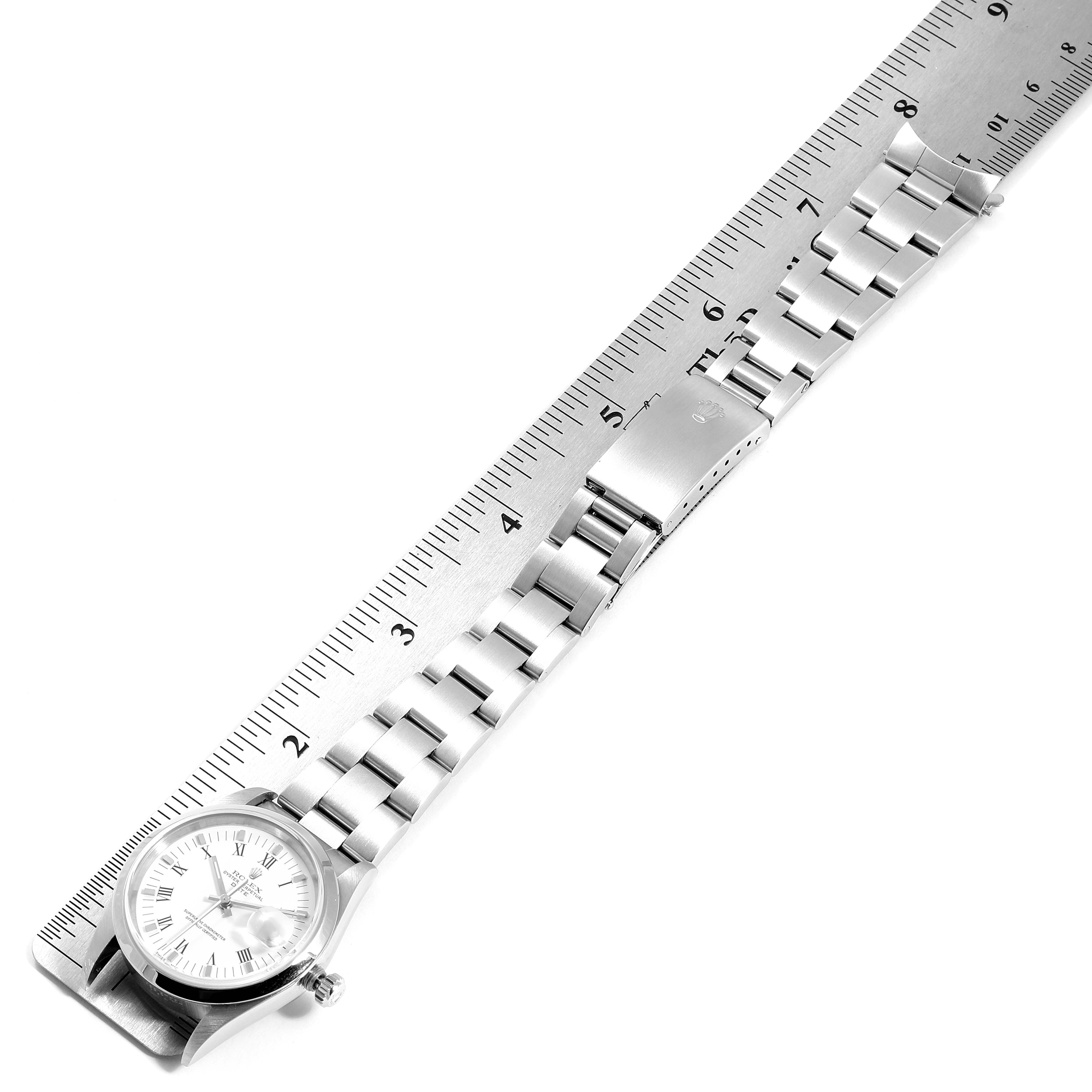 The image shows a top-down view of a Rolex Date 15200 Men's Stainless Steel White Dial 15200 Men's Stainless Steel White Dial watch with a full-length metal bracelet measured by a ruler.