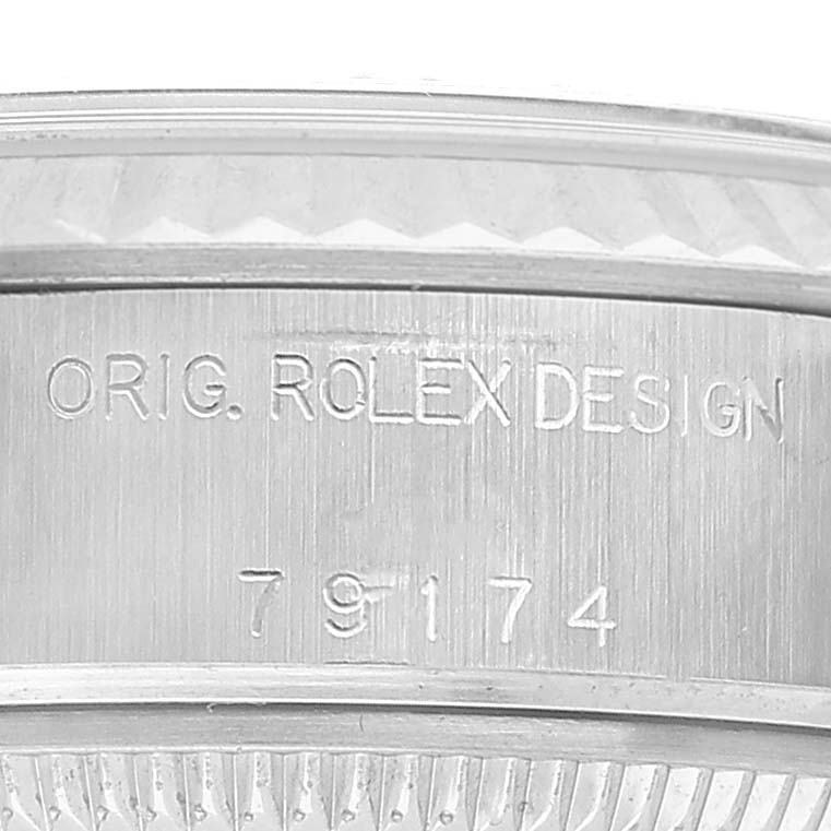 The image shows a close-up view of the side of a Rolex Datejust 79174 Women's Stainless Steel Silver Dial watch case, displaying its engraved design and model number.