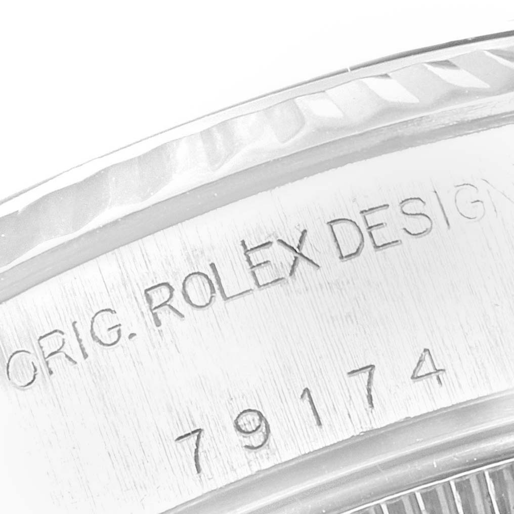 The image shows a close-up of the serial number and "ORIG. ROLEX DESIGN" engraving on the case of a Rolex Datejust 79174 Women's Stainless Steel Pink Dial 79174 Women's Stainless Steel Pink Dial watch.