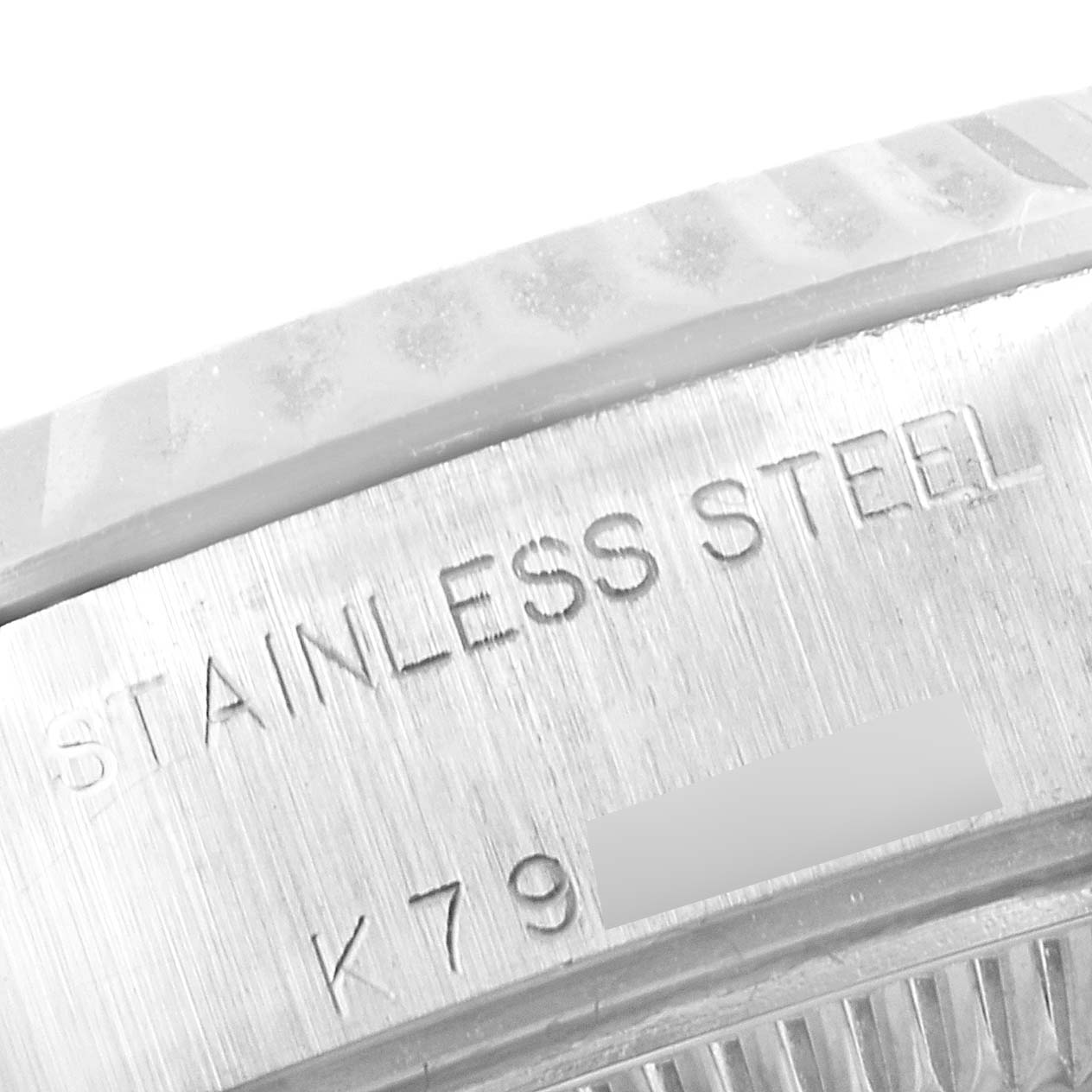 This image shows a close-up of the engraved stainless steel case back of a Rolex Datejust 79174 Women's Stainless Steel Pink Dial 79174 Women's Stainless Steel Pink Dial watch.
