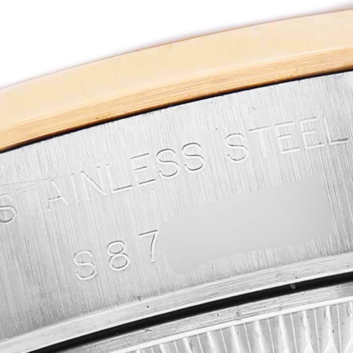 The image shows a close-up of the side casing with "STAINLESS STEEL" engraved on a Rolex Datejust 79163 Women's Steel and Gold (two tone) Grey Dial watch.