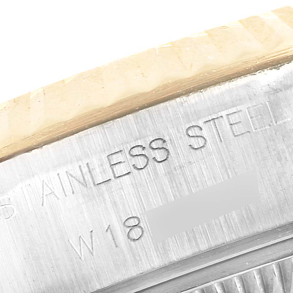 This close-up shows the engraved "STAINLESS STEEL" text on the case back side of a Rolex Datejust 69173 Women
s Steel and Gold (two tone) Champagne Dial 69173 Women
s Steel and Gold (two tone) Champagne Dial watch.