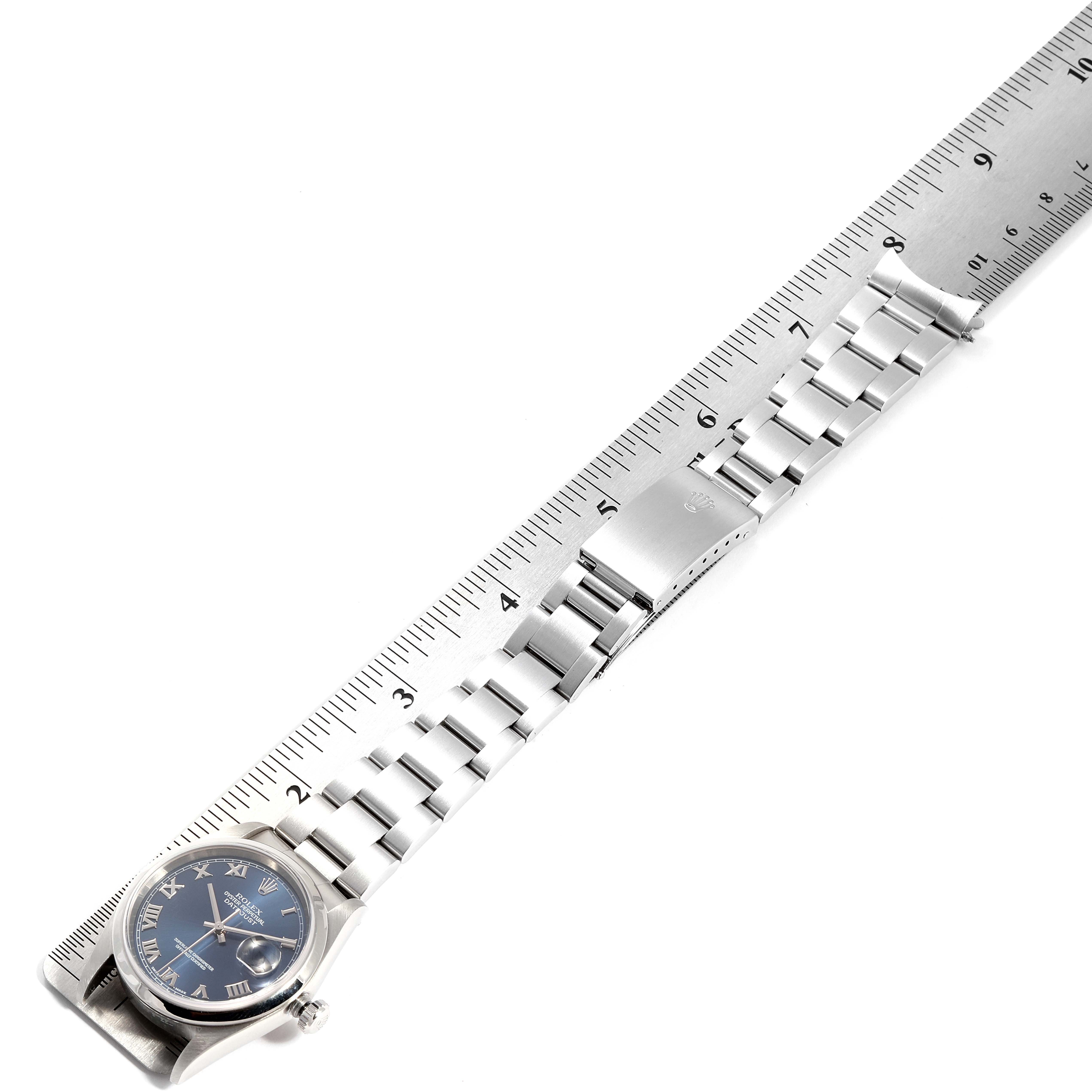 The image shows a Rolex Datejust 16200 Men's Stainless Steel Blue Dial 16200 Men's Stainless Steel Blue Dial watch lying flat with its full bracelet extended next to a ruler for measurement.