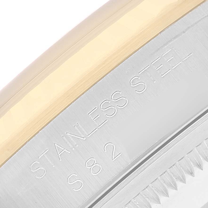 Close-up image of the case side and bezel of a Rolex Datejust 16233 Men's Steel and Gold (two tone) Blue Dial 16233 Men's Steel and Gold (two tone) Blue Dial watch, showing stainless steel inscriptions.