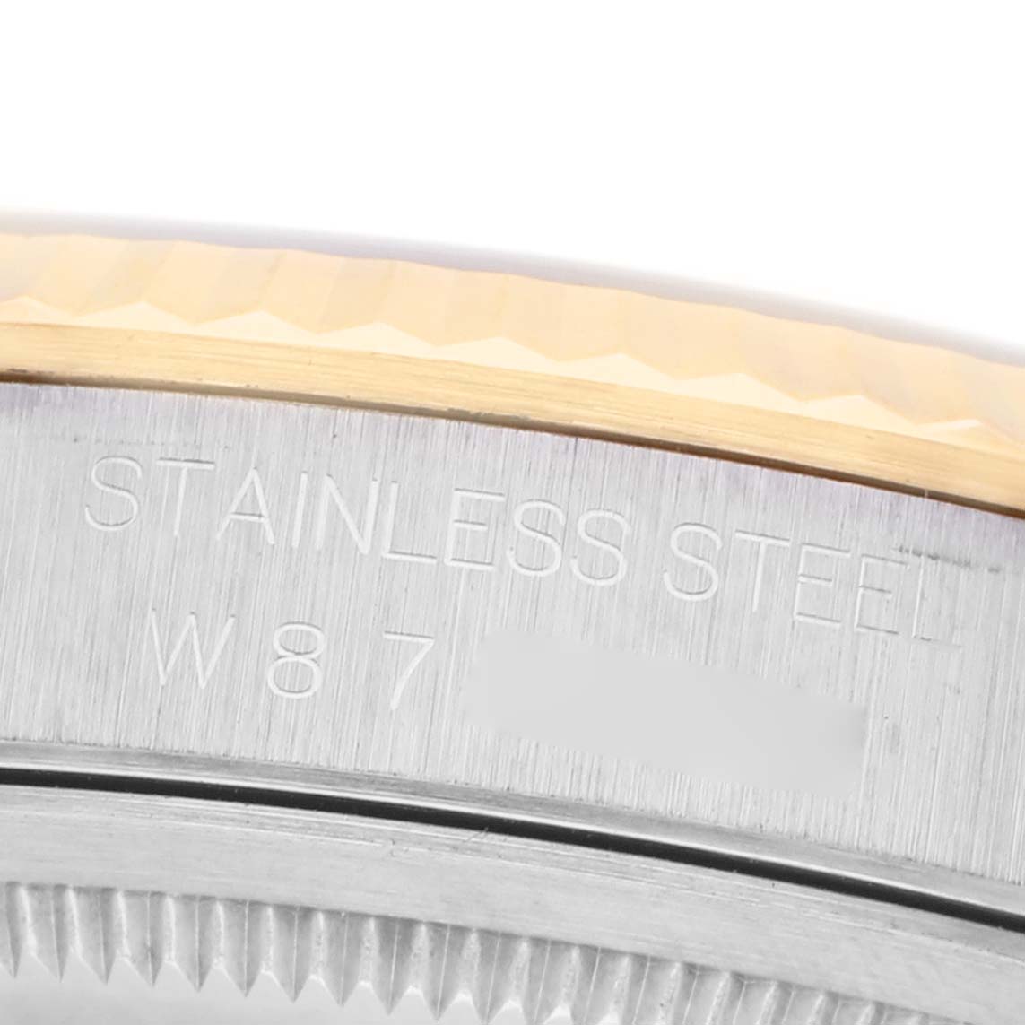 The image shows a close-up of the bezel and edge of the case back on a Rolex Datejust 16233 Men's Stainless Steel Blue Dial, highlighting the engraved markings.