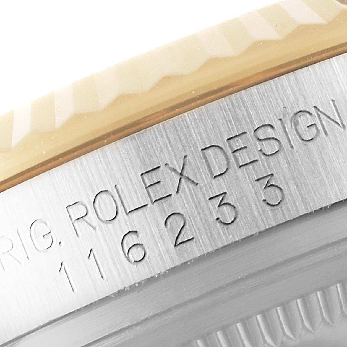 This image shows a close-up of the bezel and engraved design elements on a Rolex Datejust 116233 Men's Steel and Gold (two tone) Champagne Dial 116233 Men's Steel and Gold (two tone) Champagne Dial watch.