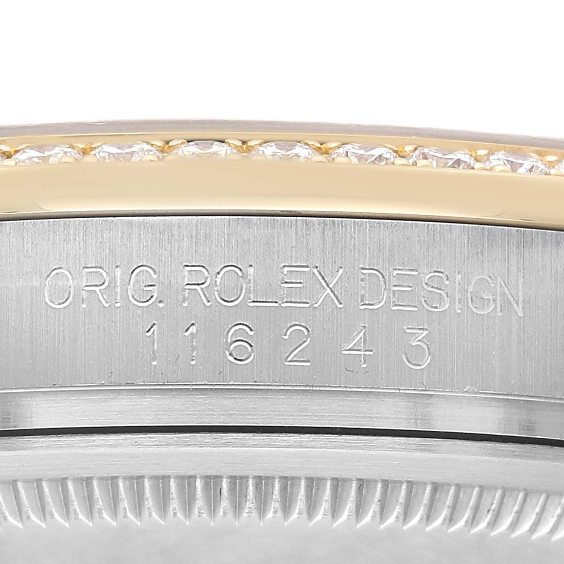The image shows the side view of a Rolex Datejust 116243 Men's Stainless Steel Silver Dial model, highlighting the engraved serial number and part of the bezel.