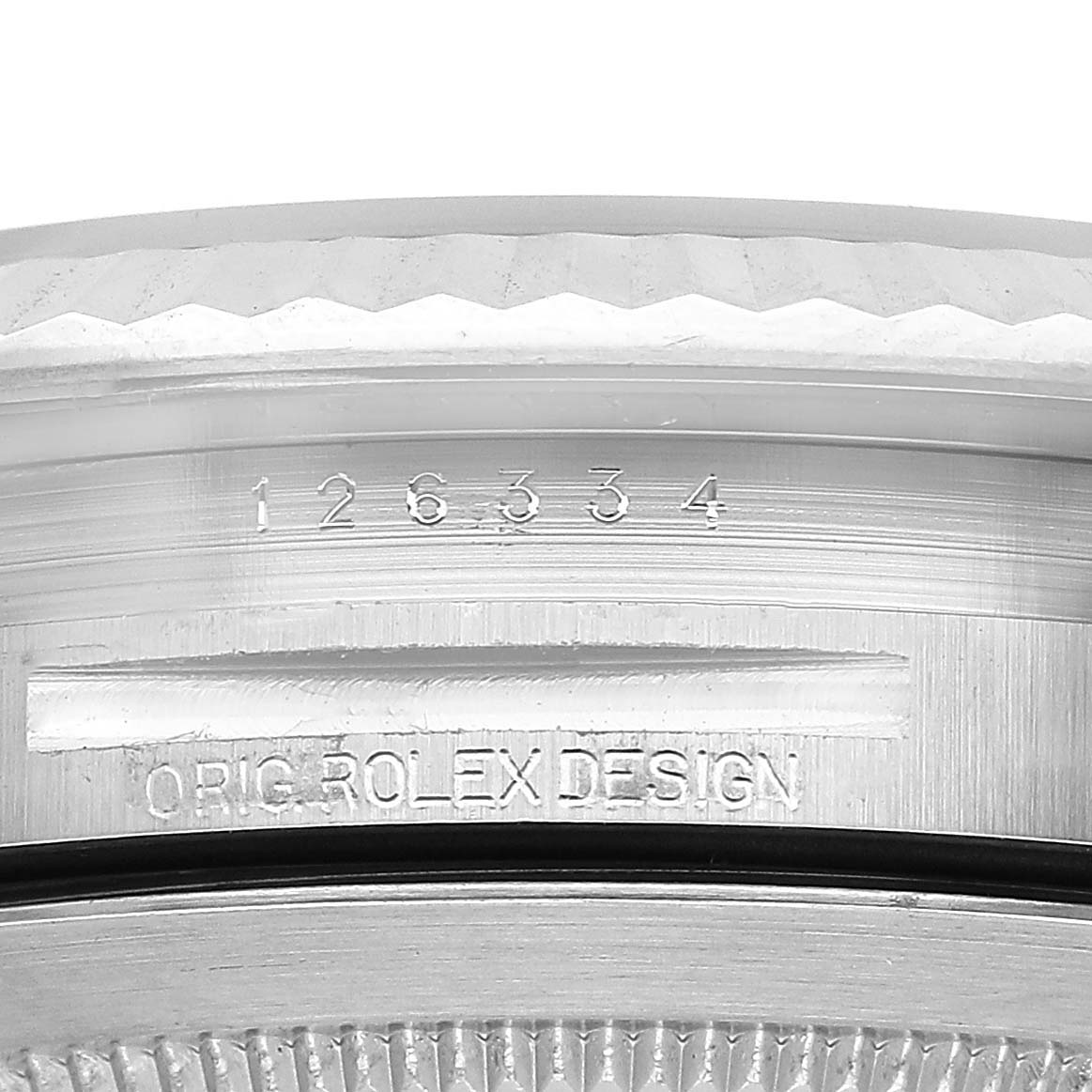 The image shows a close-up of the side of a Rolex Datejust 41 126334 Men's Stainless Steel Blue Dial, focusing on the engraved model number and design details.