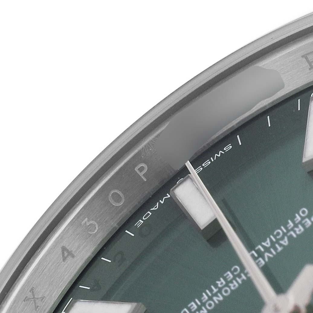 The image shows a close-up of the dial and edge of a Rolex Datejust 41 126300 Men's Stainless Steel Green Dial, featuring part of the bezel and hour markers.