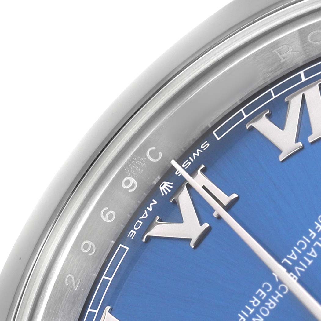 The image shows a close-up of the dial and bezel of a Rolex Datejust 41 126300 Men's Stainless Steel Blue Dial, highlighting the Roman numerals and part of the blue dial.