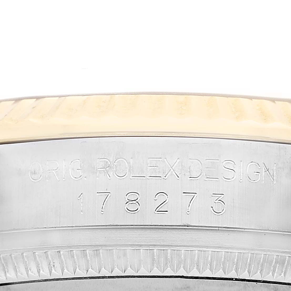 The image shows a close-up of the side of a Rolex Mid-Size 178273 Women's Steel and Gold (two tone) Champagne Dial model watch, highlighting the engraved model number and design text.