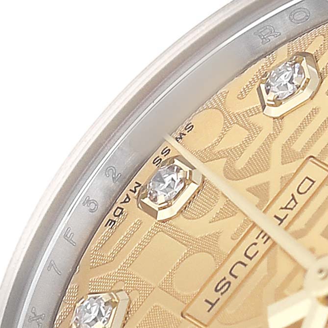 The image shows a close-up of a Rolex Mid-Size 178273 Women's Steel and Gold (two tone) Champagne Dial watch dial with diamond markers, a portion of the date window, and part of the bezel.