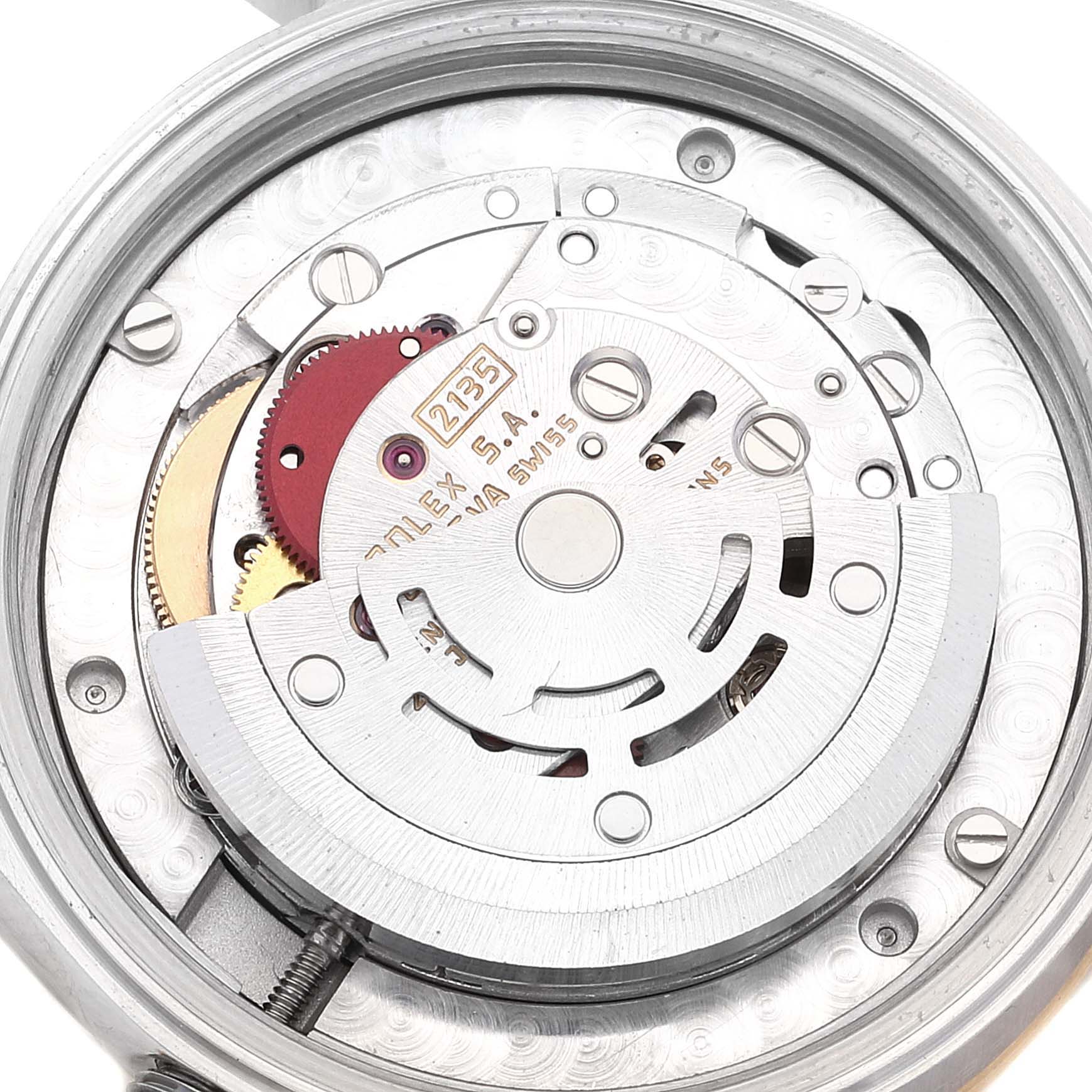 The image shows the movement and internal mechanics of a Mid-Size Rolex watch from a back view.
