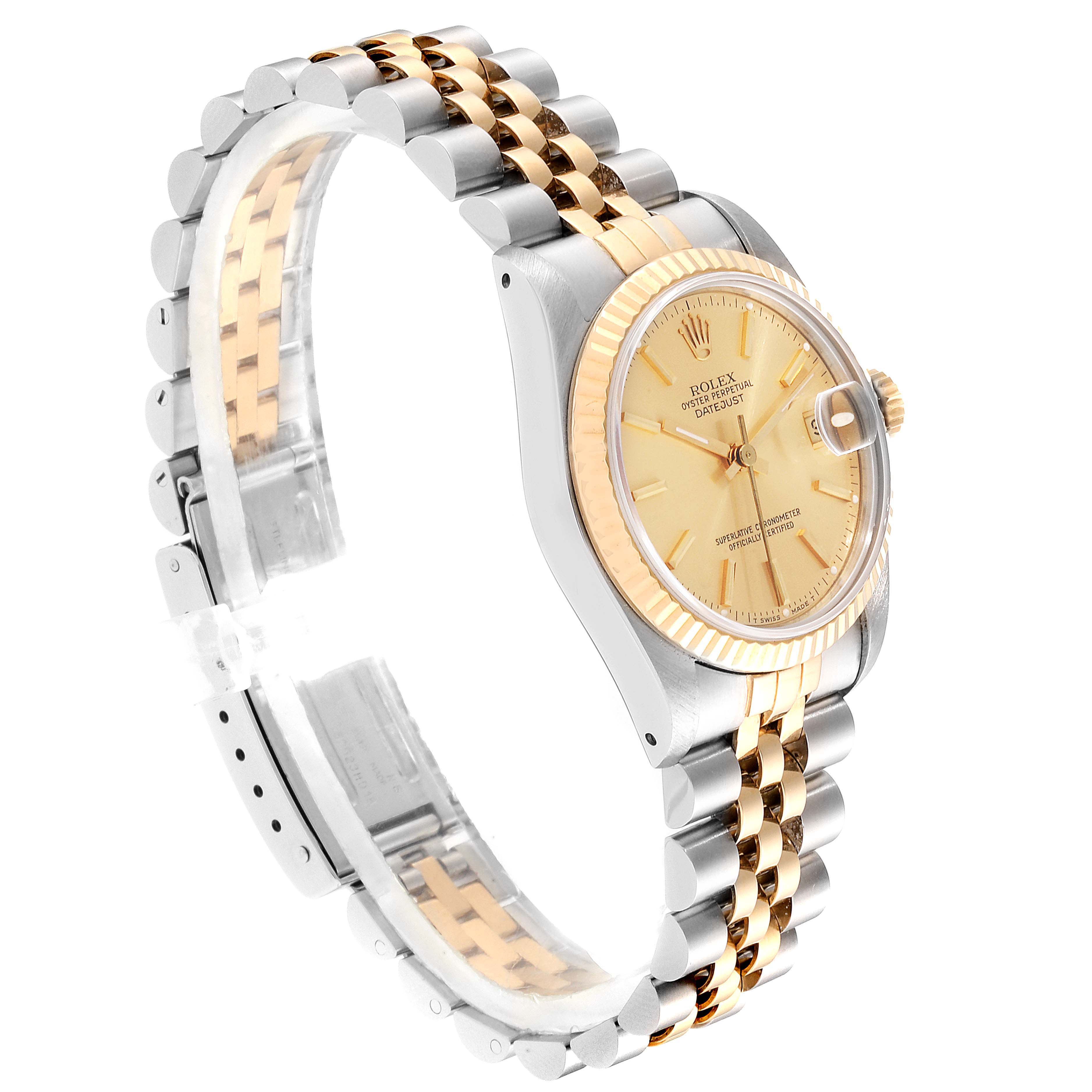 The Rolex Mid-Size 68273 Women
s Steel and Gold (two tone) Champagne Dial 68273 Women
s Steel and Gold (two tone) Champagne Dial watch is shown at a 45-degree angle, displaying its gold and silver jubilee bracelet, and the face with the crown and magnified date.