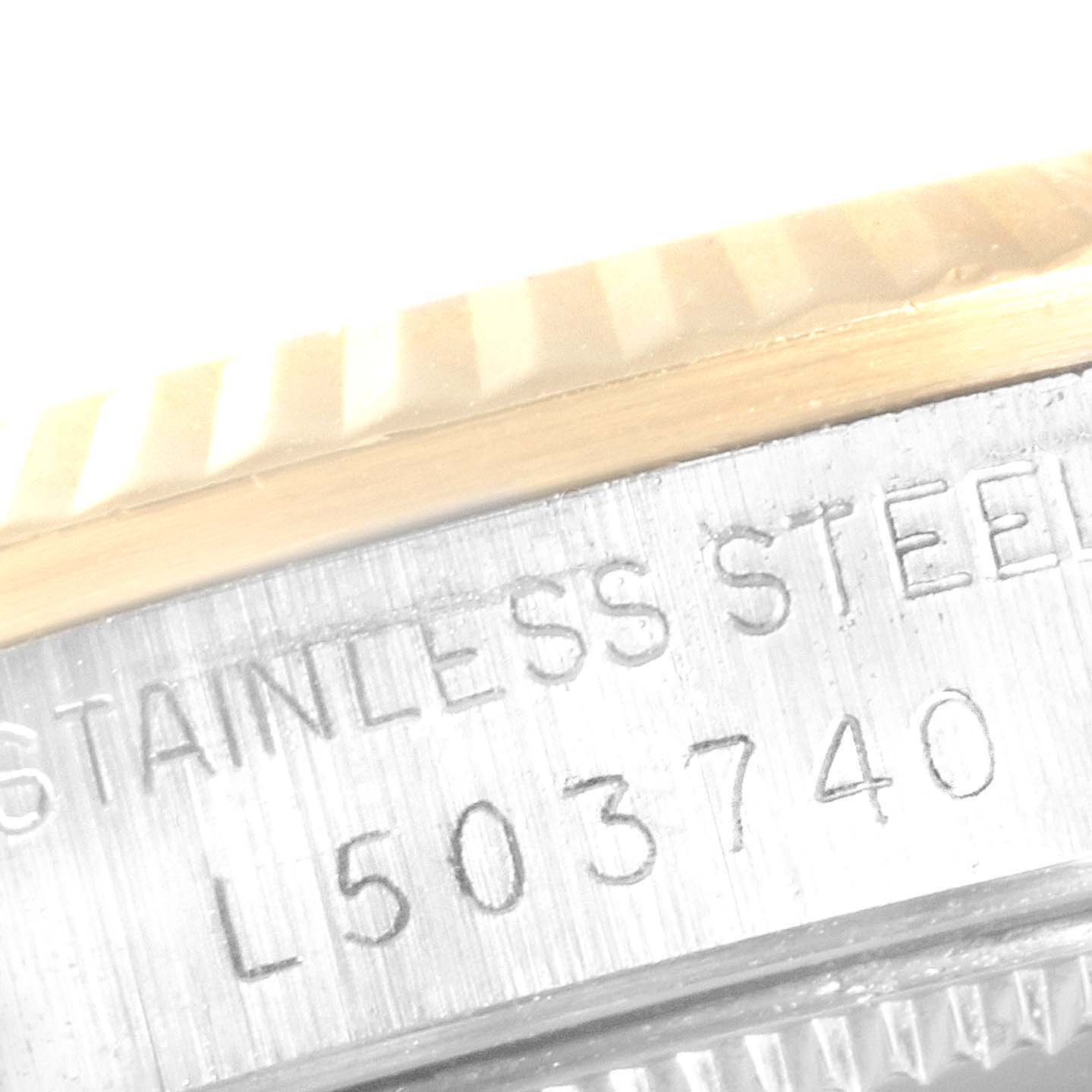 The image shows a close-up angle of the stainless steel case and serial number of a Rolex Mid-Size 68273 Women
s Steel and Gold (two tone) Champagne Dial 68273 Women
s Steel and Gold (two tone) Champagne Dial model.