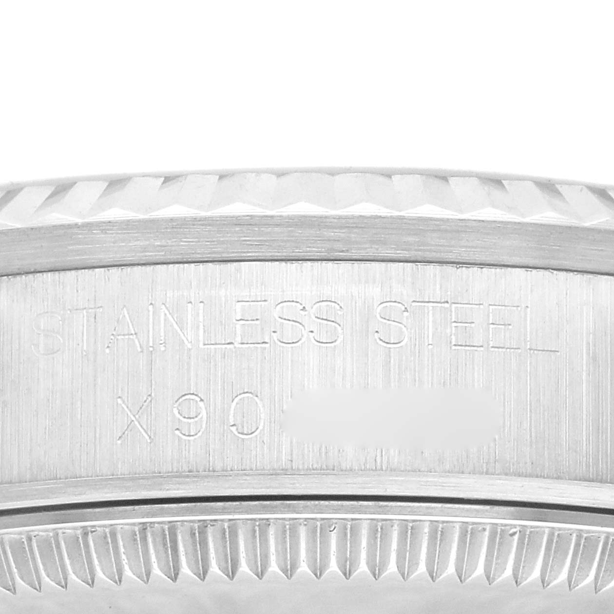 This image shows the side case and bezel of a Mid-Size Rolex watch, focusing on the "Stainless Steel" engraving.