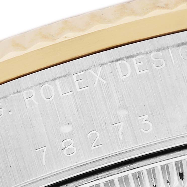 This image shows a close-up of the Rolex Mid-Size 78273 Women's Steel and Gold (two tone) Mother of Pearl Dial 78273 Women's Steel and Gold (two tone) Mother of Pearl Dial model's case back with the model number and "Rolex Design" engraving.