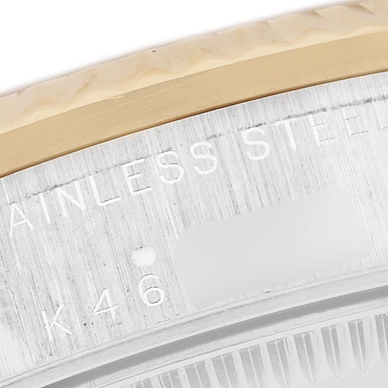 This close-up image shows the edge of the bezel and part of the case with engravings of a Rolex Mid-Size 78273 Women's Steel and Gold (two tone) Mother of Pearl Dial 78273 Women's Steel and Gold (two tone) Mother of Pearl Dial model watch.