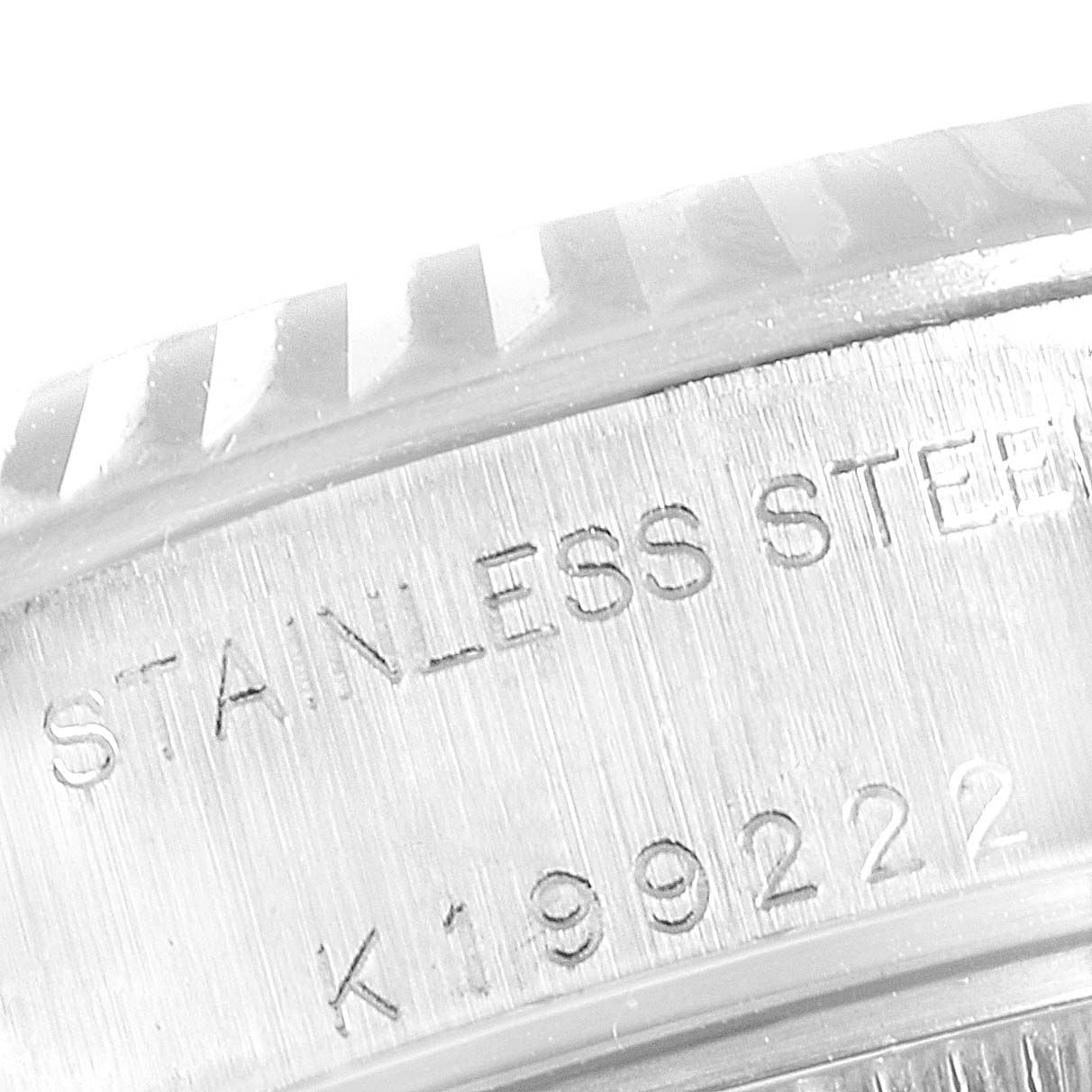 The image shows a close-up of the side engraving and part of the bezel of a Rolex Datejust 79174 Women
s Stainless Steel Mother of Pearl Dial 79174 Women
s Stainless Steel Mother of Pearl Dial watch.