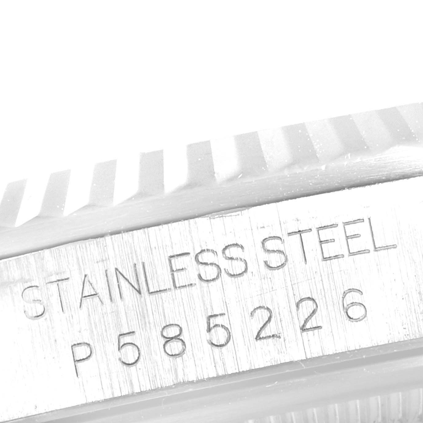 This close-up image of the Rolex Datejust 16234 Men's Stainless Steel Silver Dial 16234 Men's Stainless Steel Silver Dial watch shows the serial number and stainless steel engraving on the case side.