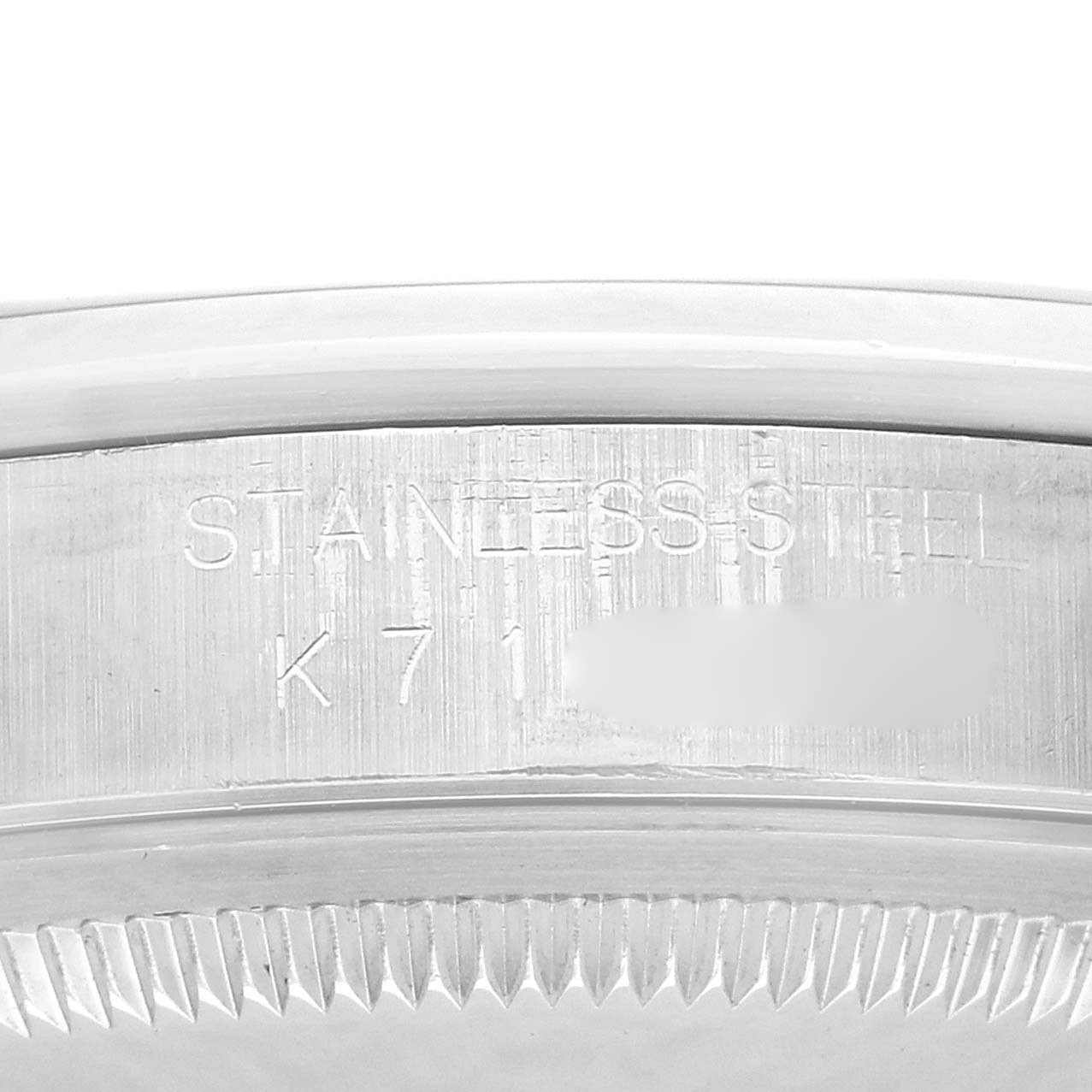 The image shows a close-up of the Rolex Datejust model 16200's stainless steel case with visible engravings.