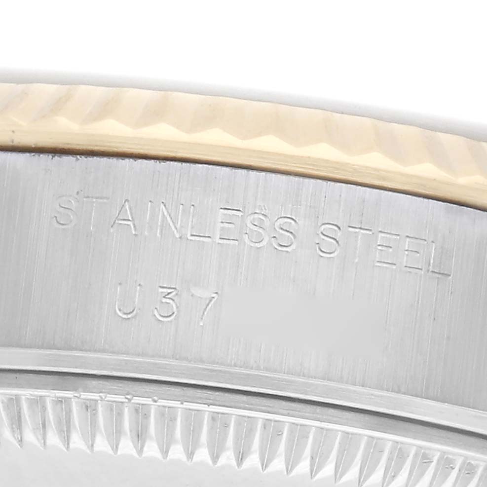 The image shows a close-up of the edge and engraving on the case back of a Rolex Datejust model 69173, highlighting the "STAINLESS STEEL" inscription.