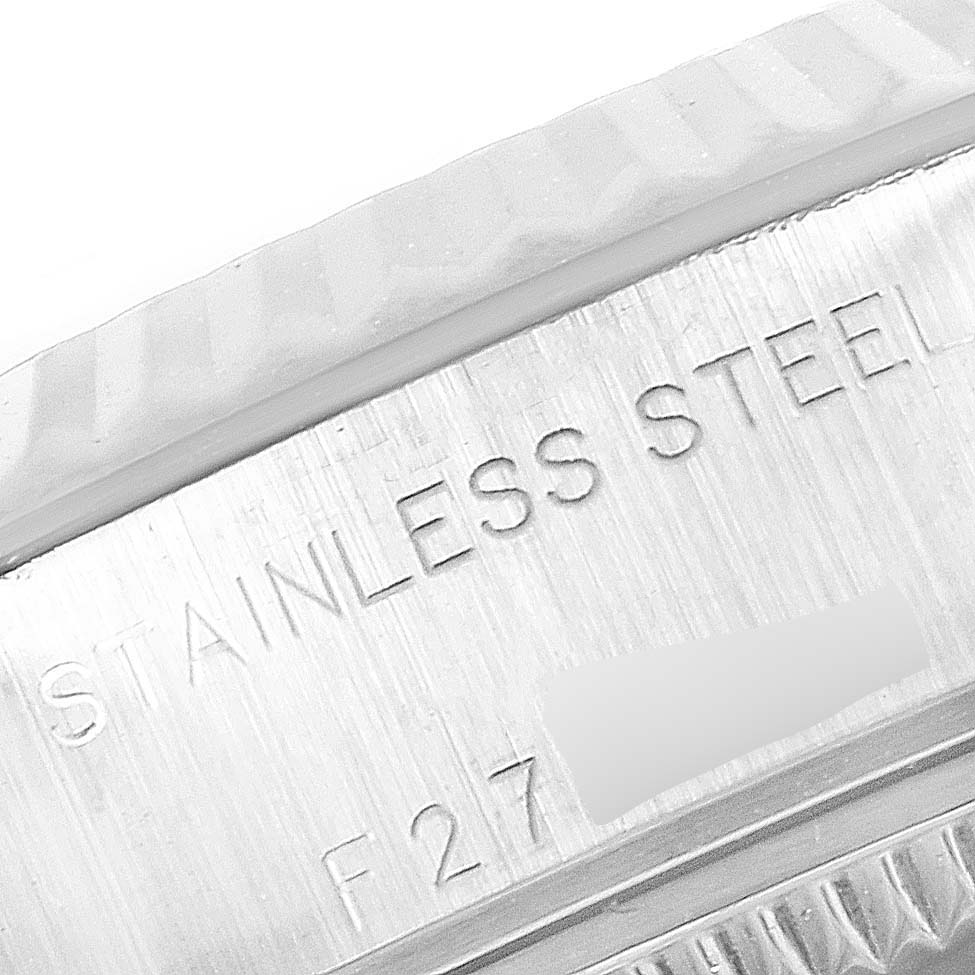 The image shows a close-up of the stainless steel case edge, marked with "STAINLESS STEEL" on a Rolex Datejust 79174 Women
s Stainless Steel Black Dial 79174 Women
s Stainless Steel Black Dial model.