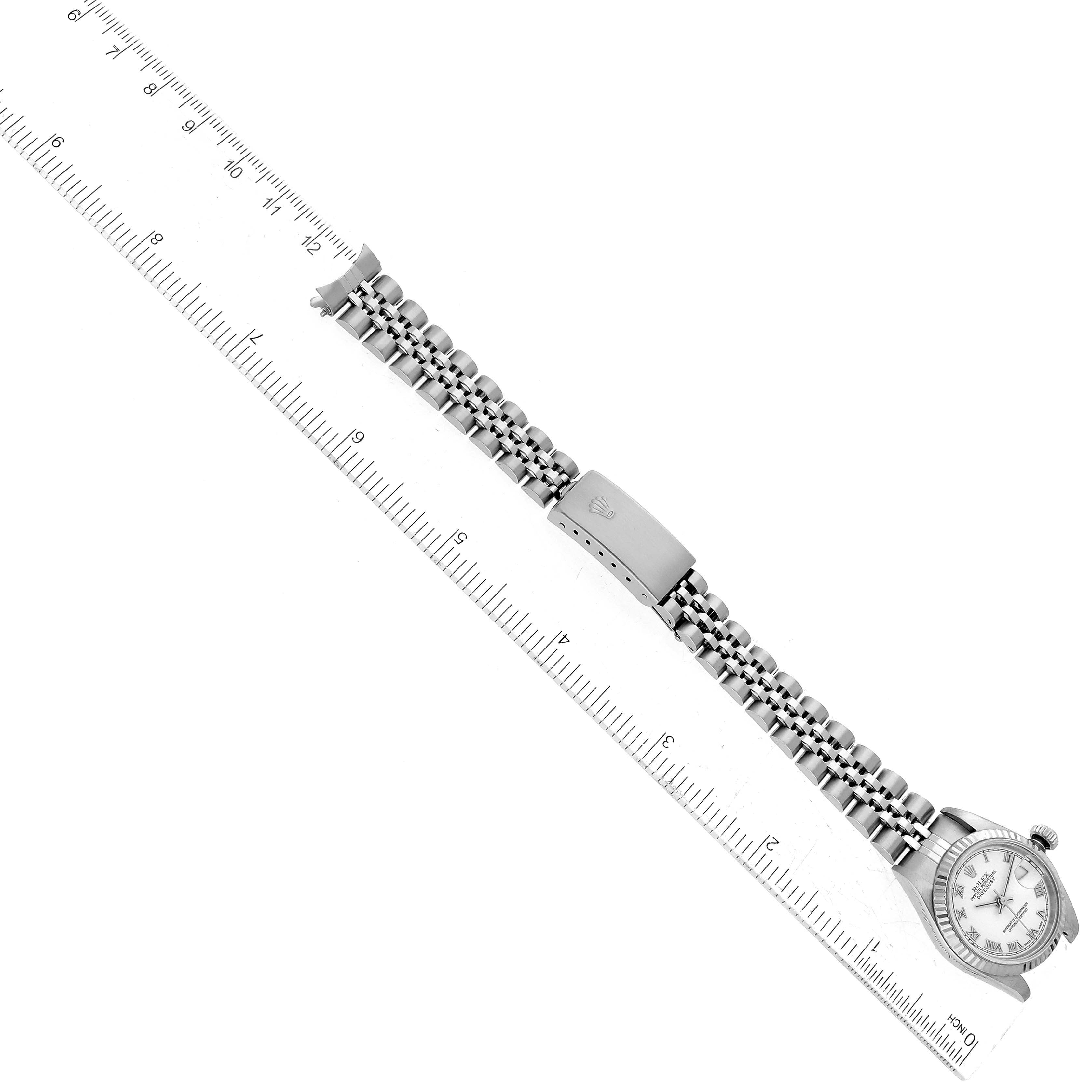 The image shows a Rolex Datejust 79174 Women's Stainless Steel White Dial 79174 Women's Stainless Steel White Dial watch positioned at a diagonal angle with the bracelet fully extended and a ruler for scale.
