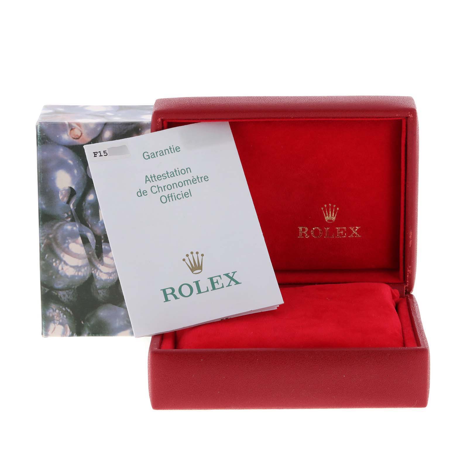 The image shows a Rolex Datejust 79174 Women
s Stainless Steel Silver Dial 79174 Women
s Stainless Steel Silver Dial watch box open with a warranty card placed inside and an additional outer box visible behind it.