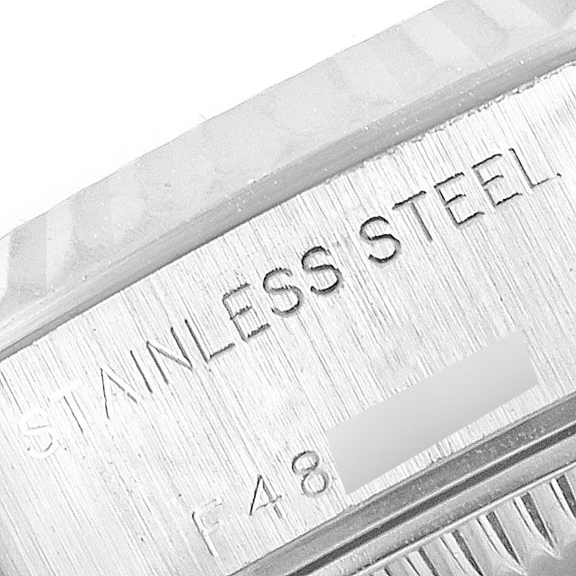 The image shows a close-up of the stainless steel engraving on the casing edge of a Rolex Datejust 79174 Women
s Stainless Steel White Dial 79174 Women
s Stainless Steel White Dial watch.