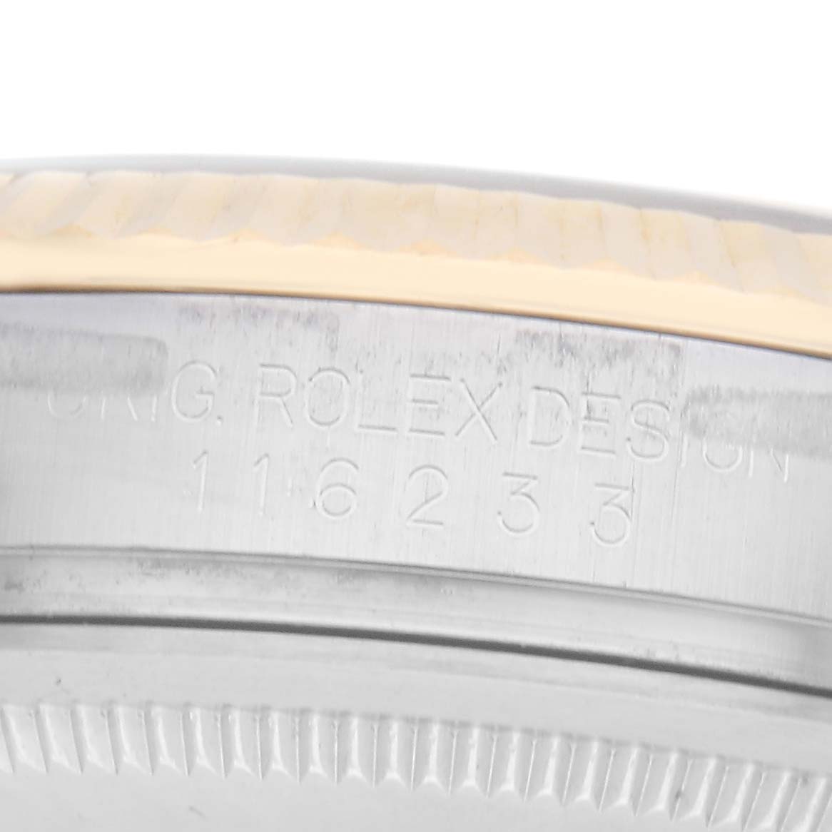 The image shows a close-up of the side of the case of a Rolex Datejust, model number 116233, displaying its engraved model number and part of the fluted bezel.