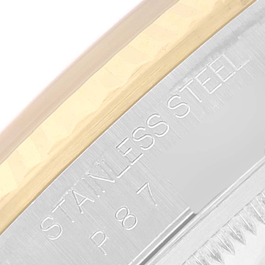 This image shows a close-up of the stainless steel and gold bezel of a Rolex Datejust 16233 Men's Steel and Gold (two tone) Black Dial 16233 Men's Steel and Gold (two tone) Black Dial model.