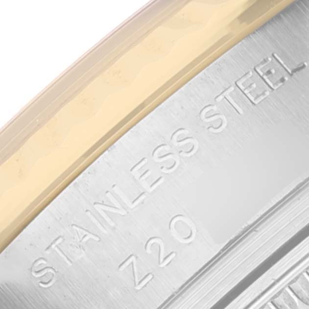 This is an angled close-up of the side engraving on the stainless steel case of a Rolex Datejust 179173 Women's Steel and Gold (two tone) Champagne Dial 179173 Women's Steel and Gold (two tone) Champagne Dial watch.
