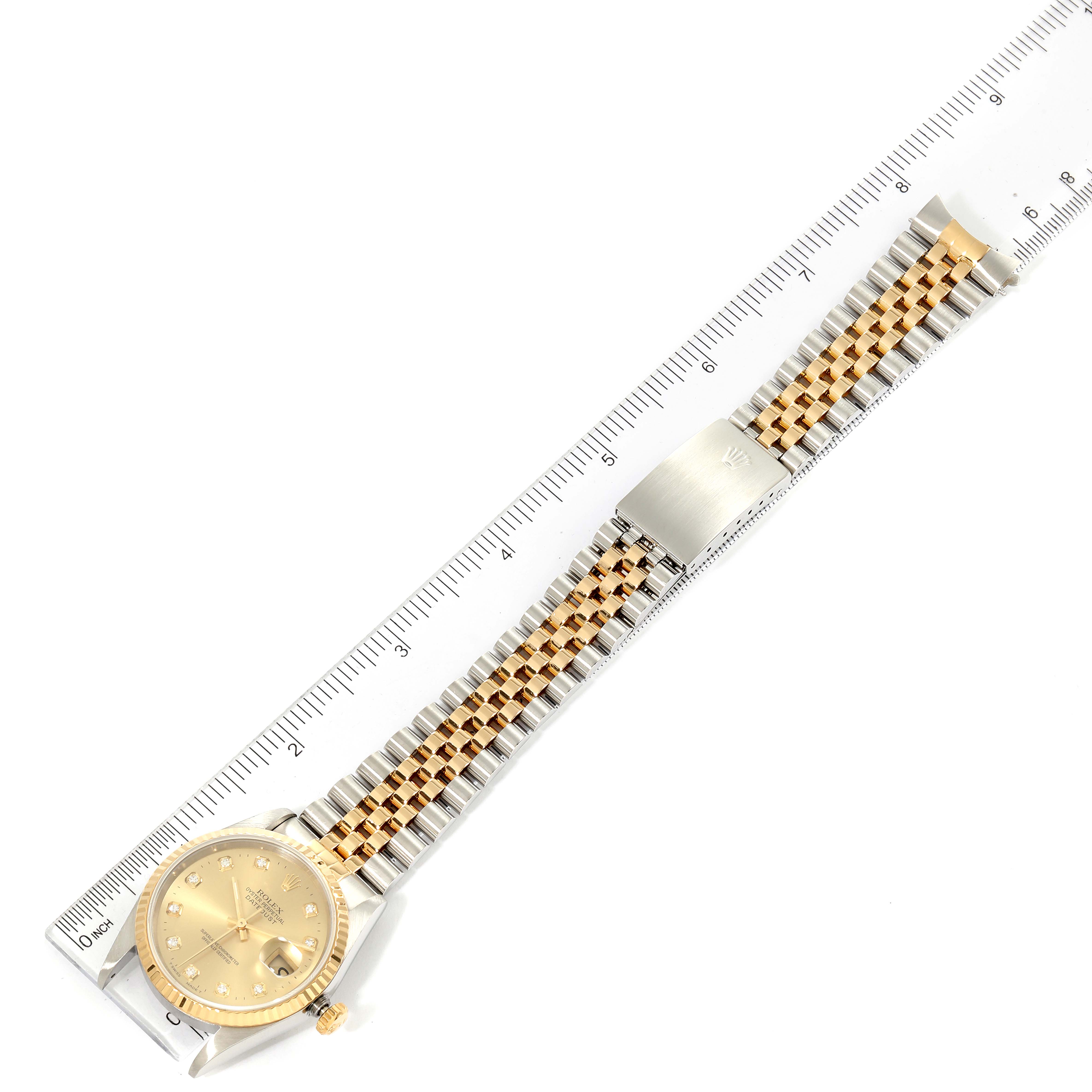 The image shows a top-down view of a Rolex Datejust 16233 Men's Steel and Gold (two tone) Champagne Dial 16233 Men's Steel and Gold (two tone) Champagne Dial watch with a two-tone wristband aligned next to a ruler for measurement.