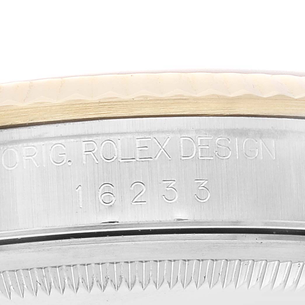 This close-up image of the Rolex Datejust 16233 Men's Steel and Gold (two tone) Champagne Dial 16233 Men's Steel and Gold (two tone) Champagne Dial watch shows the model number and part of the bezel.